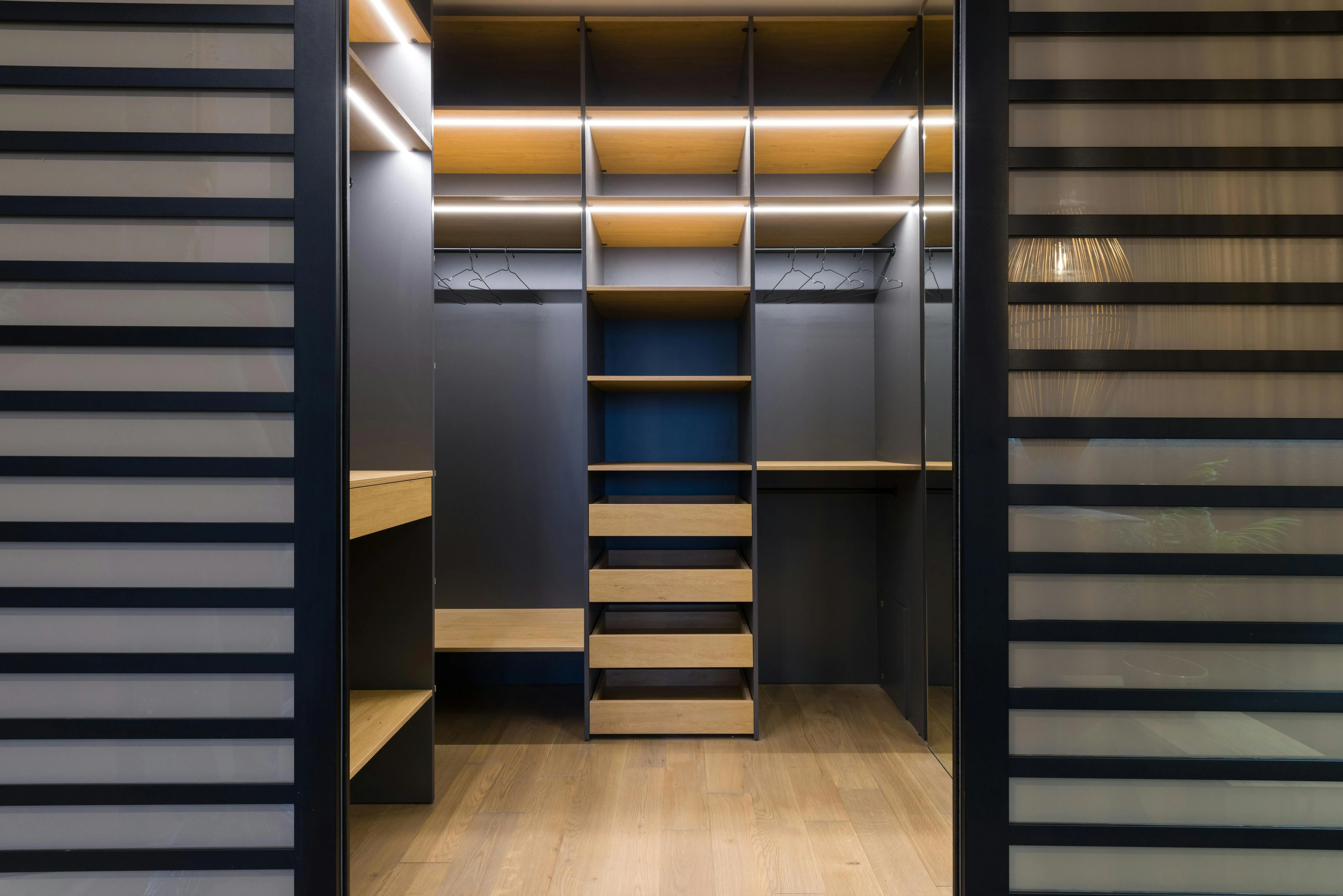 closetmaid shelving Spacious luxury walk-in closet with modern wooden shelving and stylish lighting.