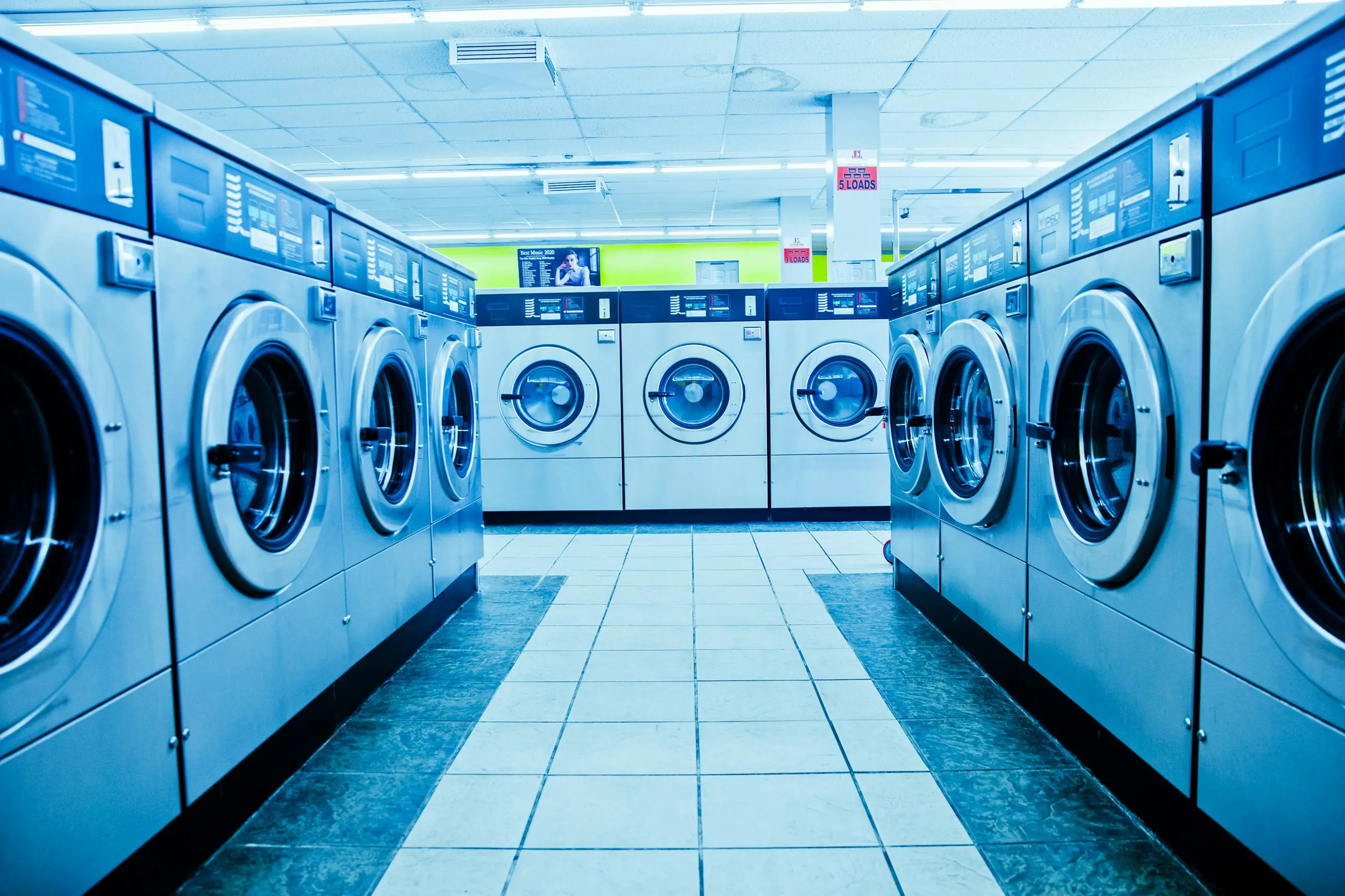what can i use instead of laundry detergent A contemporary laundromat with rows of industrial washing machines and bright interior lighting.