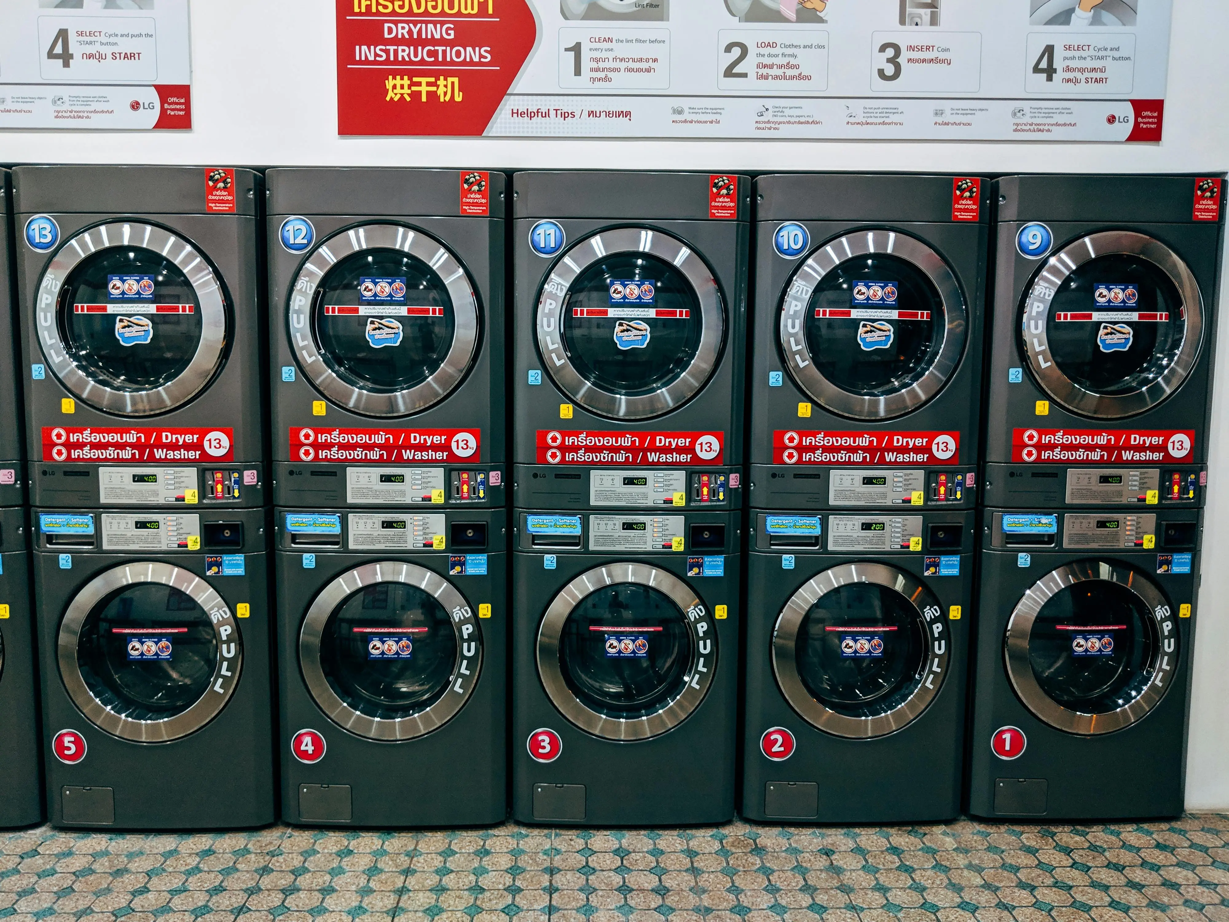 how much does a washing machine weigh A row of modern washing machines in a public laundromat in Chiang Mai, Thailand.
