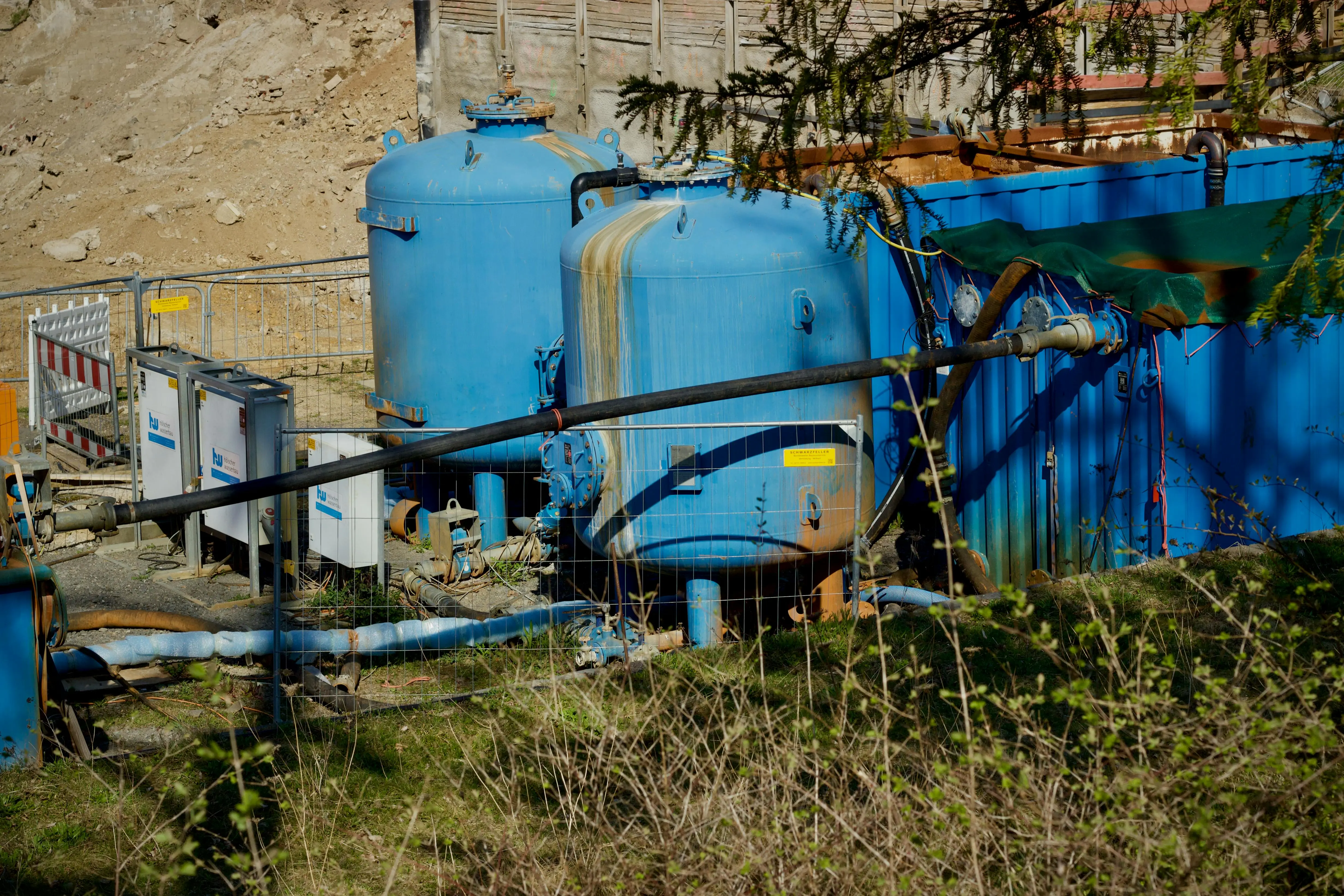 get rid of calcium deposit marks sink Outdoor industrial water filtration plant with large blue tanks under sunlight.