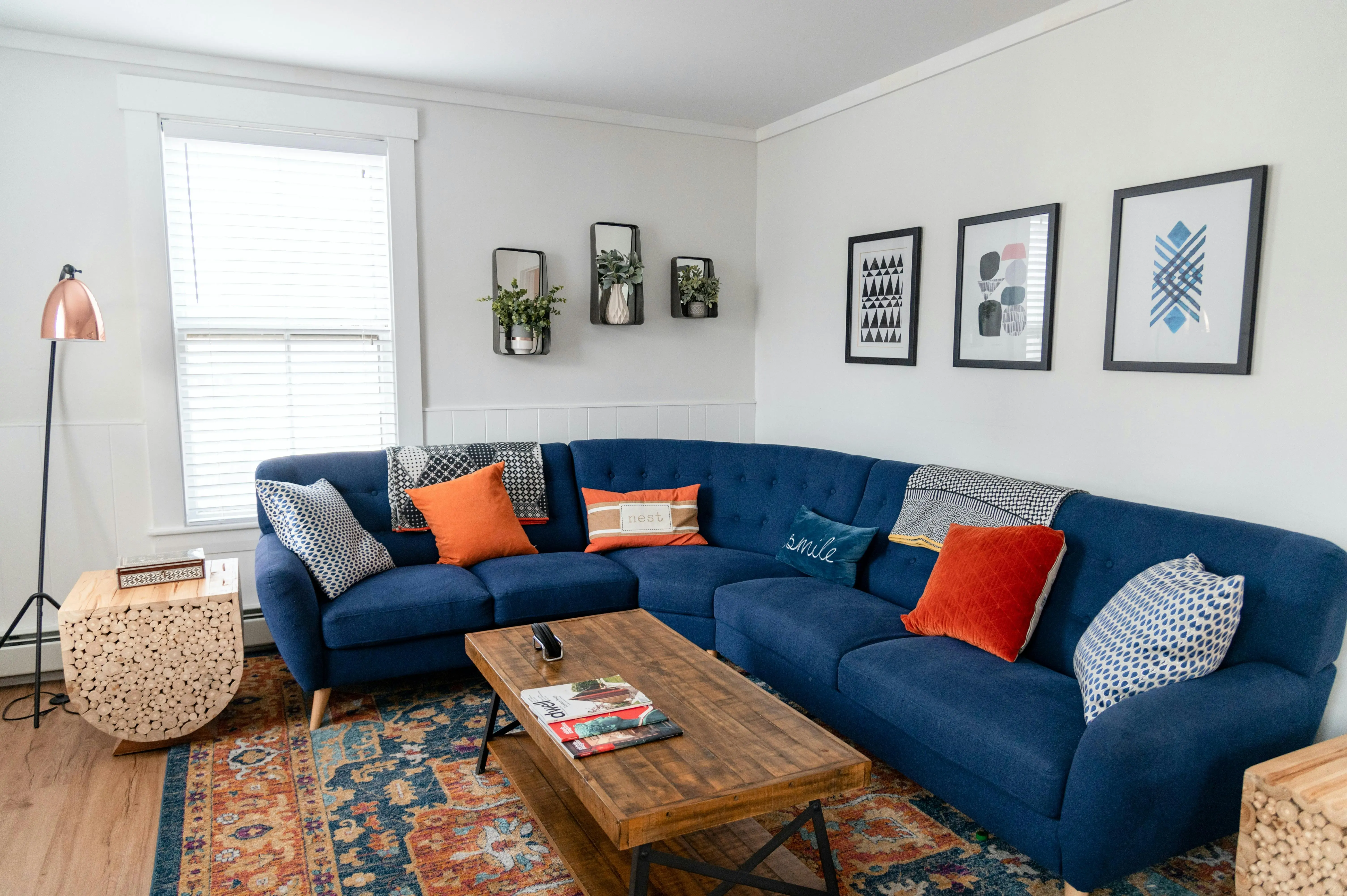 blue sectional sofa Bright and stylish living room featuring a blue sectional, vibrant pillows, and modern decor.