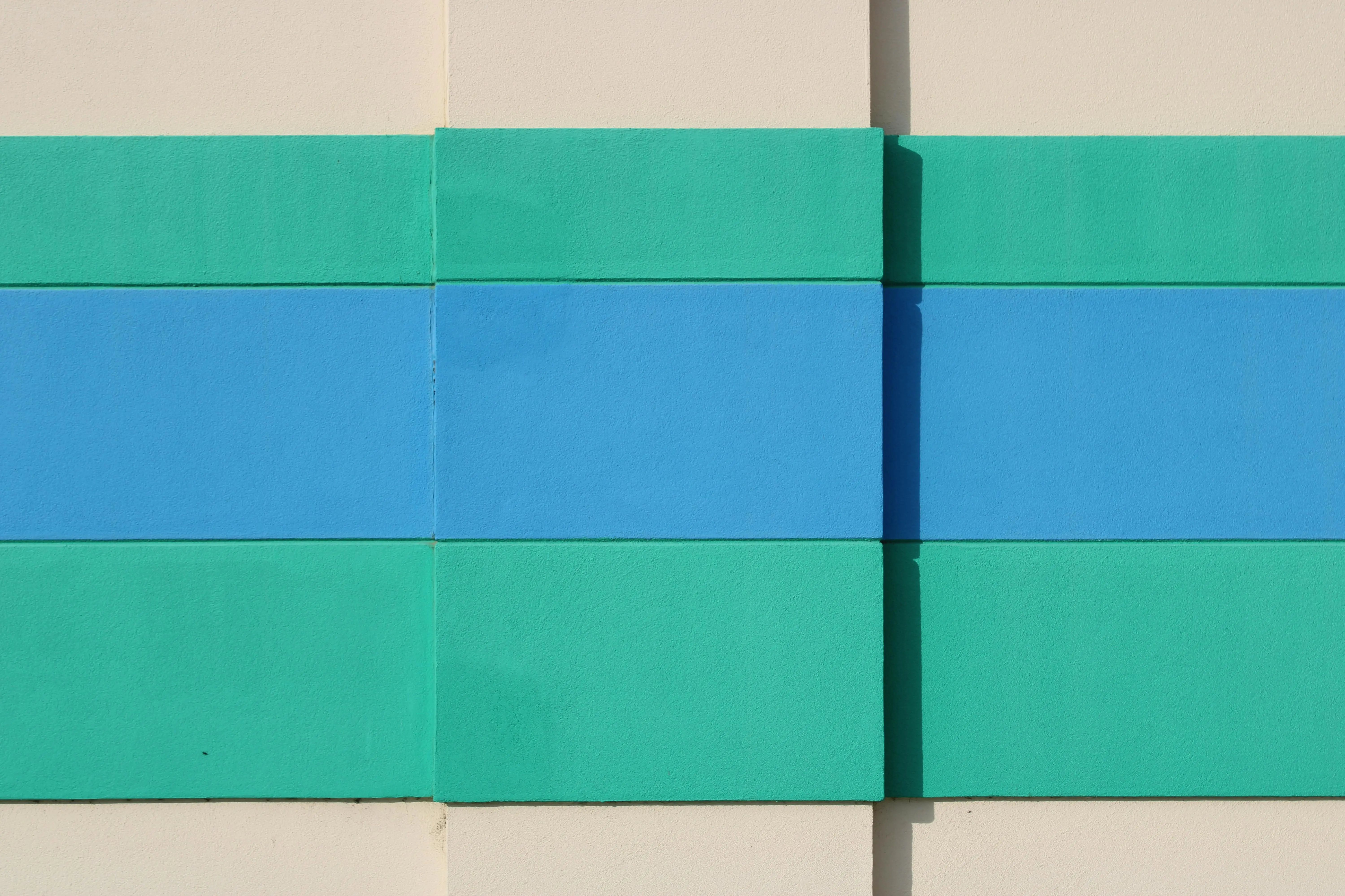 blue sectional sofa Abstract wall art in teal and blue hues on a beige background, creating a vibrant composition.