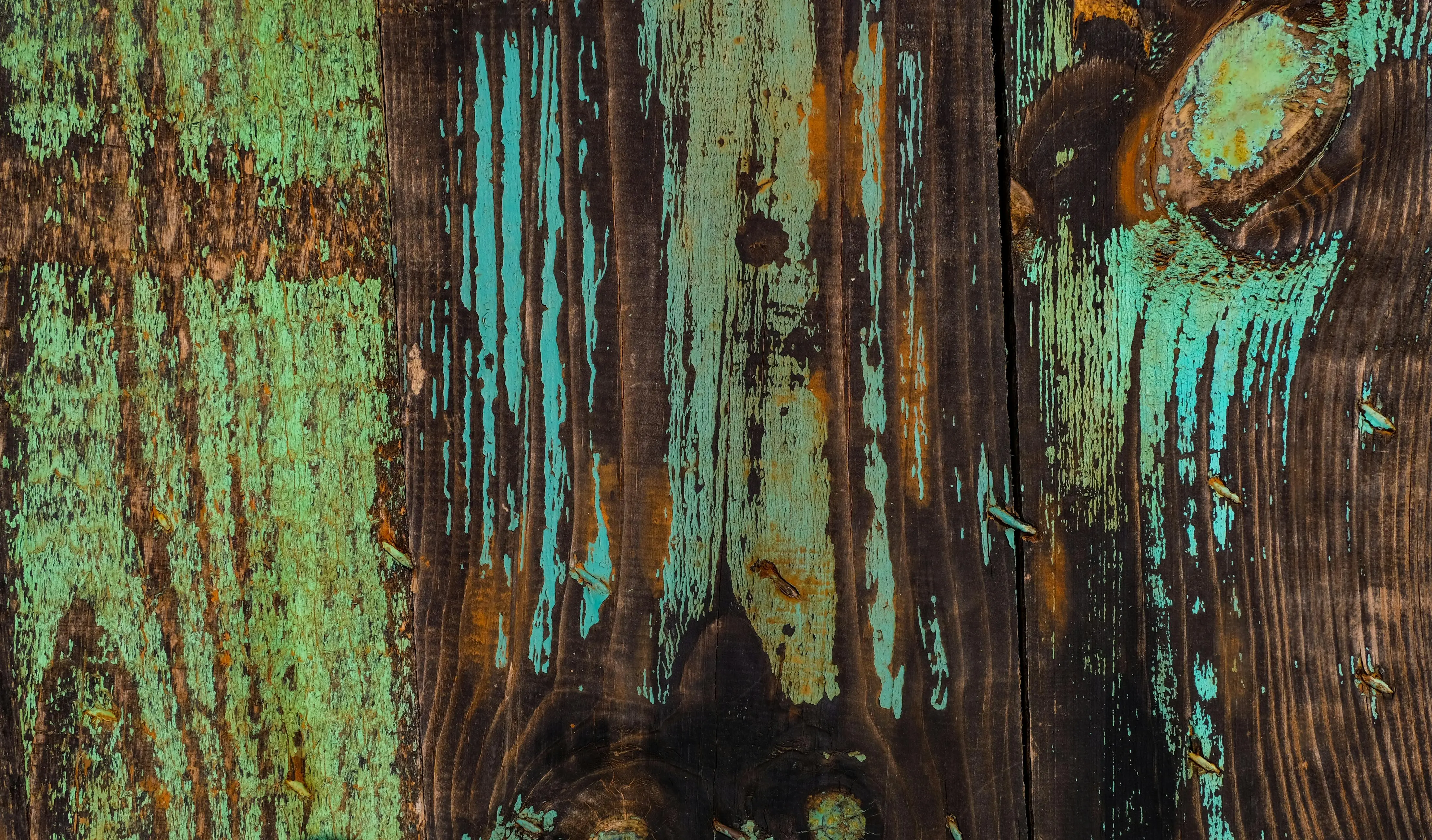 painted furniture chalk paint Close-up of rustic wooden planks with peeling turquoise paint, showcasing aged texture.