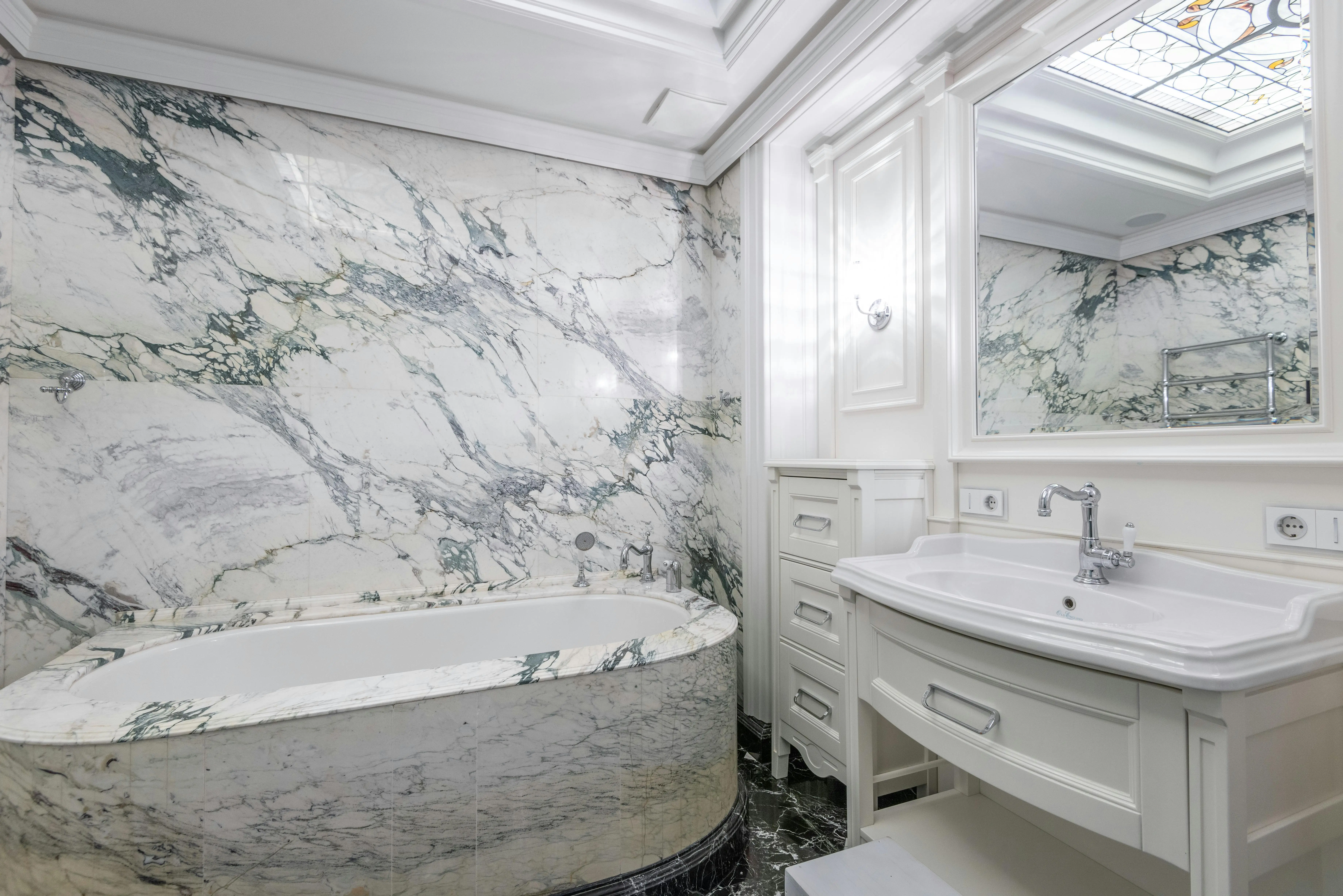 green marble Elegant bathroom with marble walls and modern fixtures creating a luxurious at-home experience.
