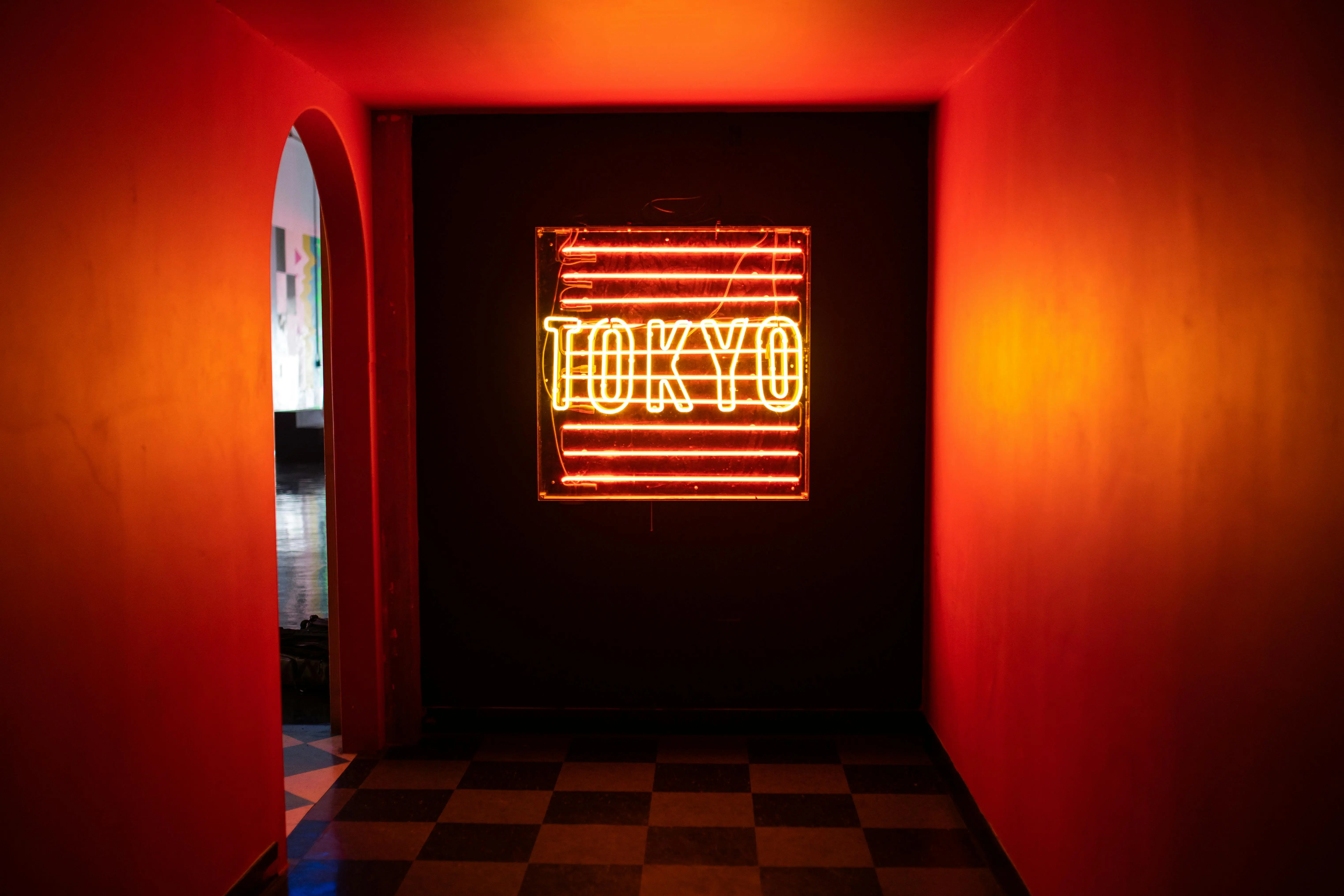 hallway art Vibrant neon sign spelling 'TOKYO' in a dimly lit hallway creates a mysterious ambiance.