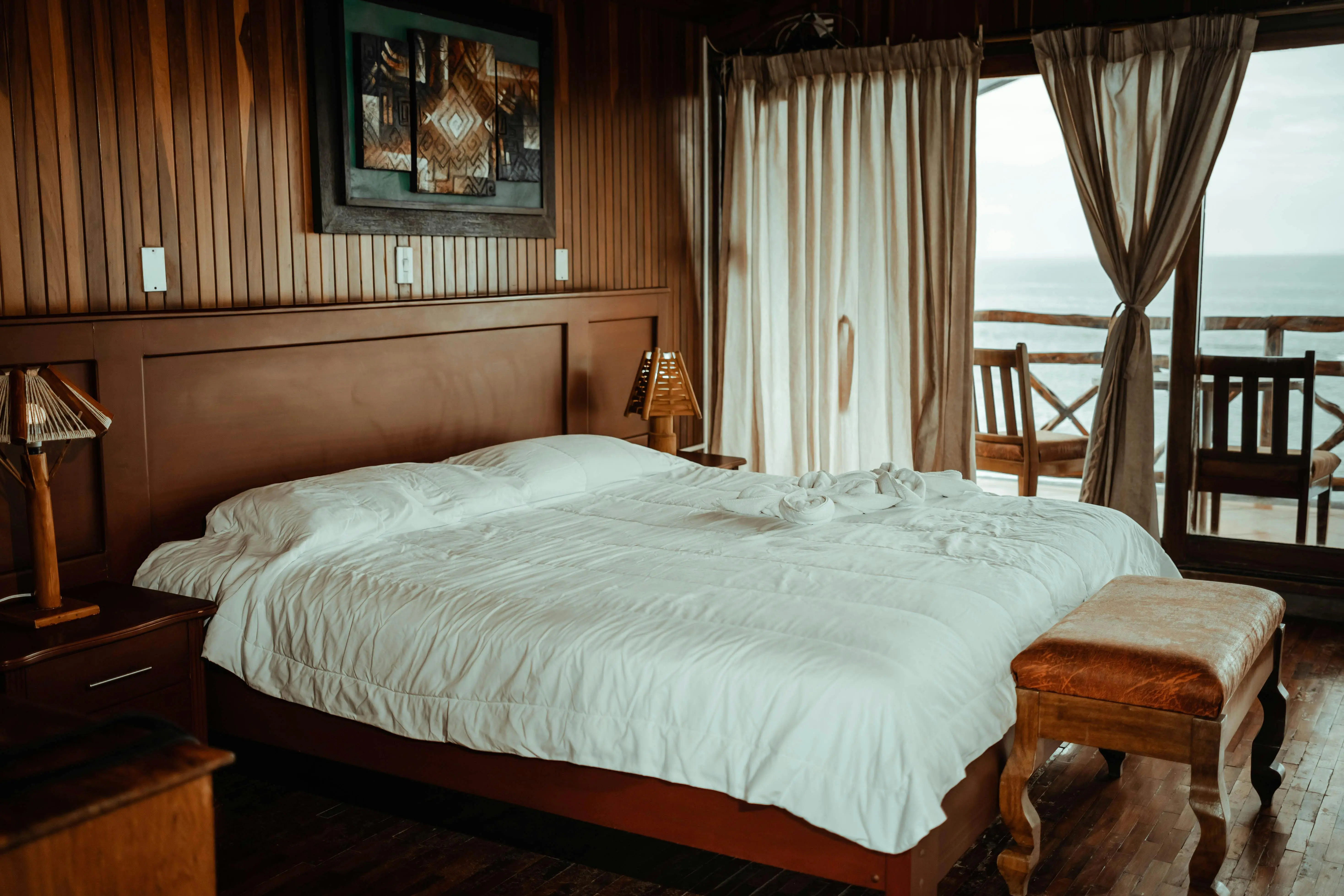king platform bed with storage Elegant hotel room with a cozy bed and ocean view. Perfect for relaxation.
