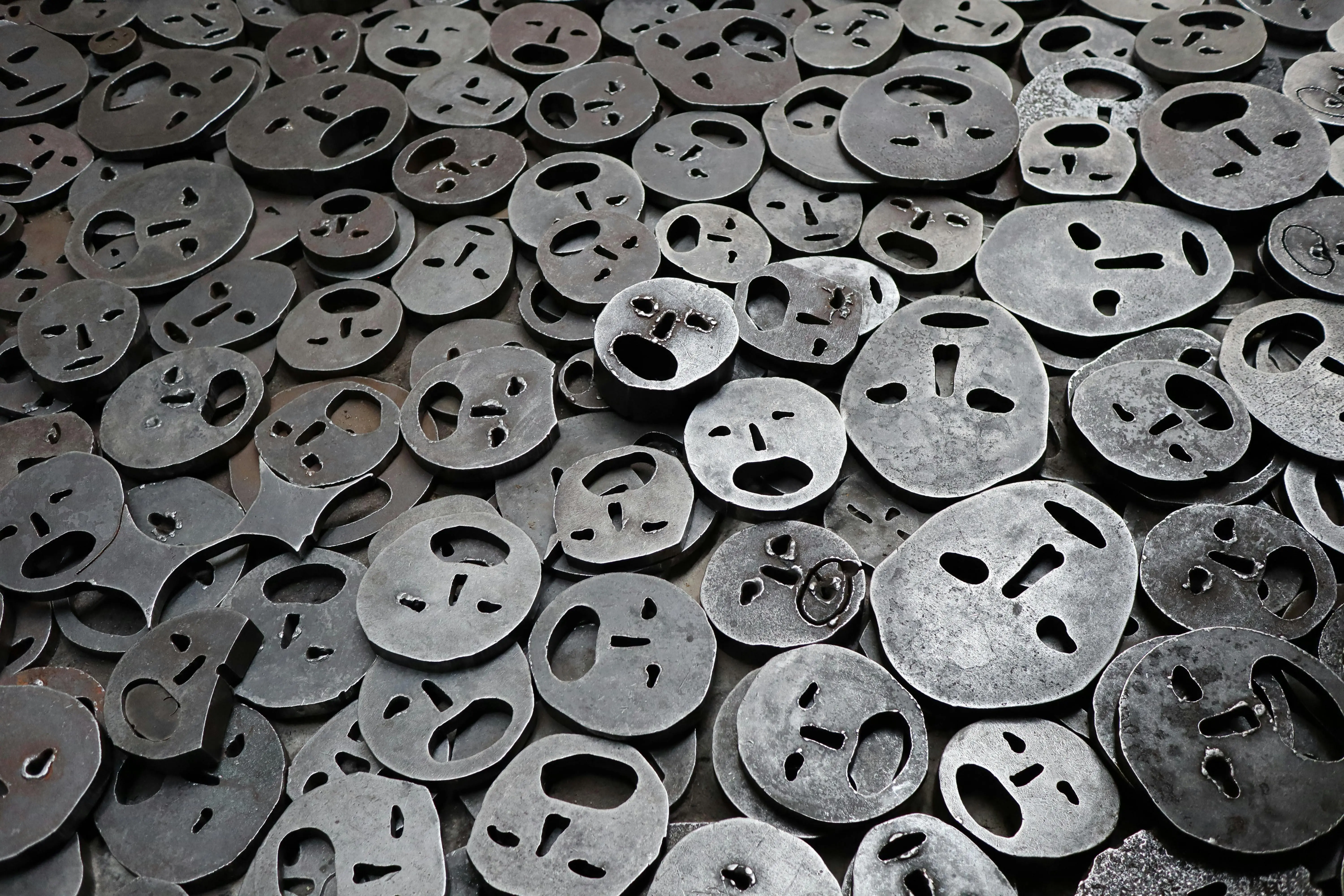 wall sculpture Modern art installation featuring metal face sculptures in Berlin, Germany.