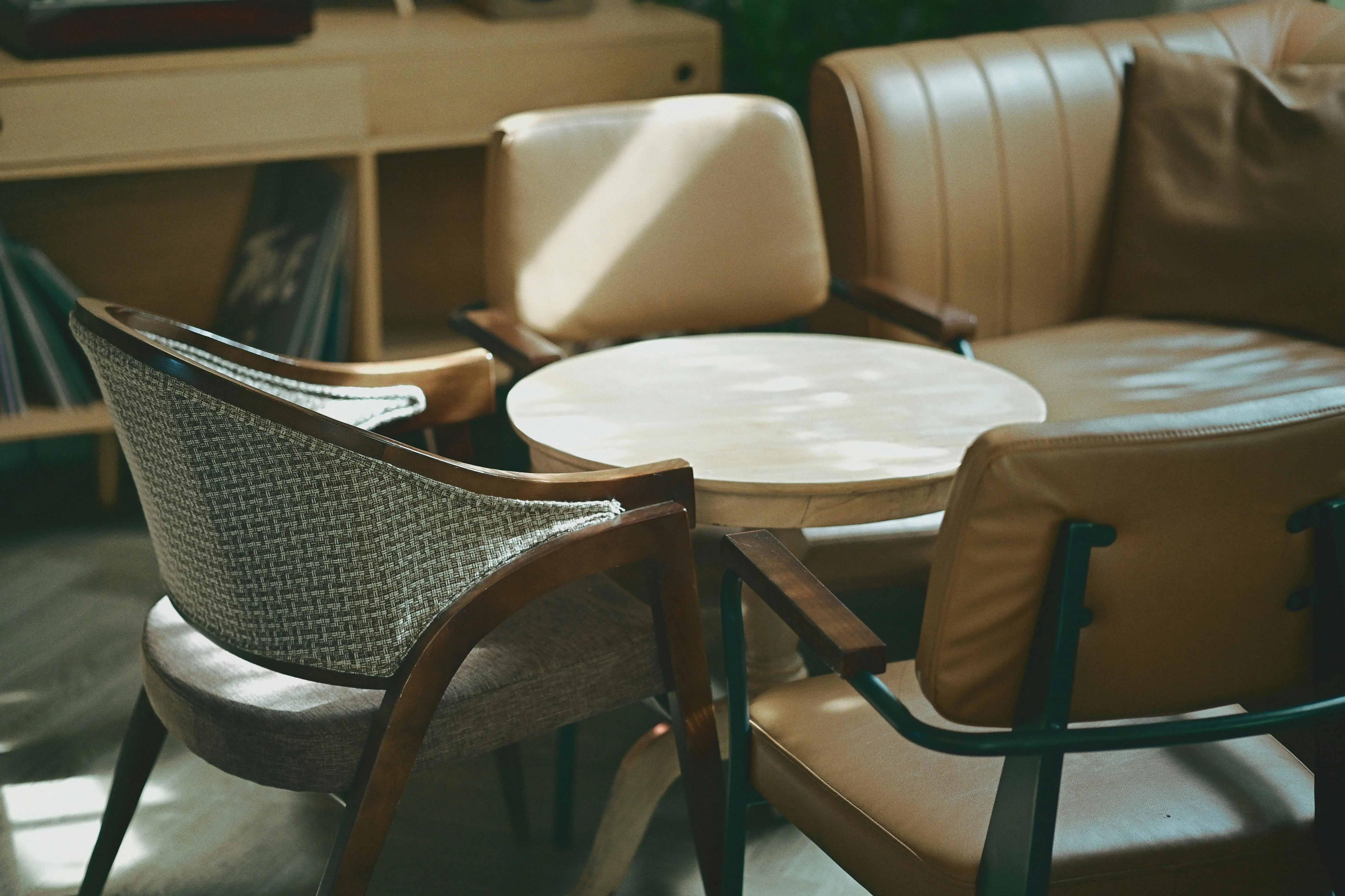 mid century modern art Mid-century modern chairs and sofa in a sunlit living room setting.