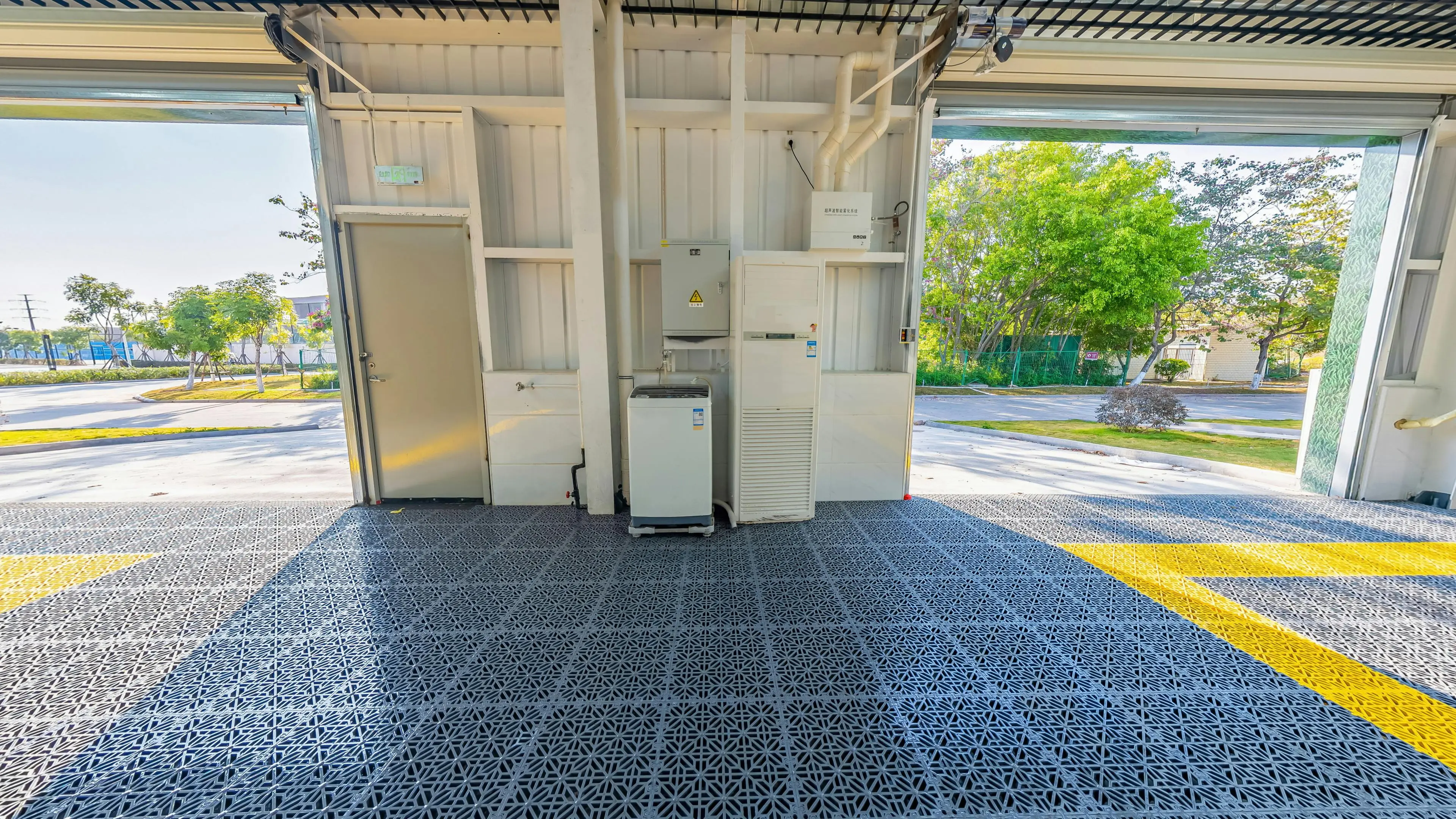 garage doors with windows Spacious open garage with durable metal grid flooring and equipment setup facing outdoors.