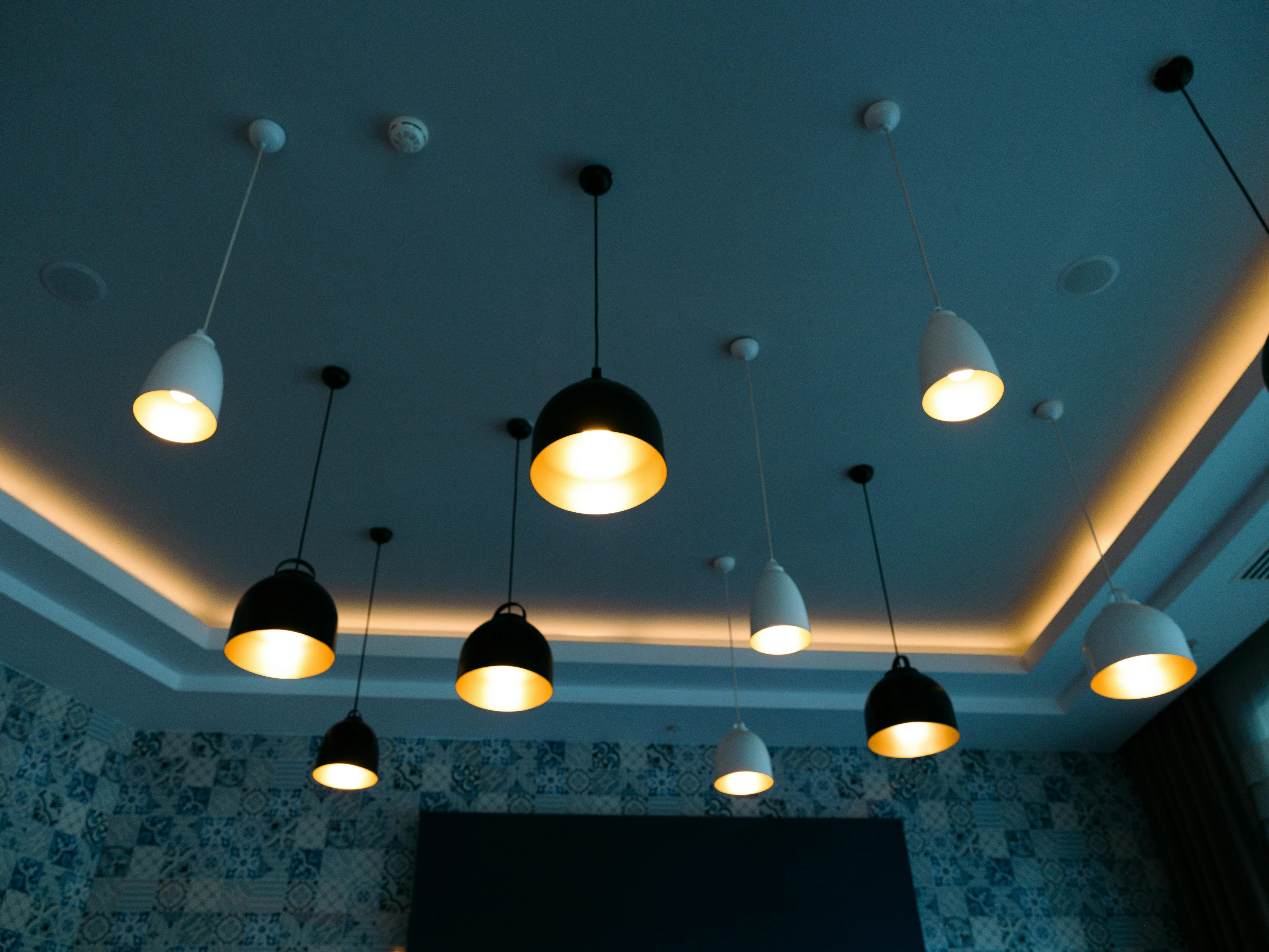 tall table lamps Stylish pendant lamps illuminate a modern interior with a chic, contemporary design.