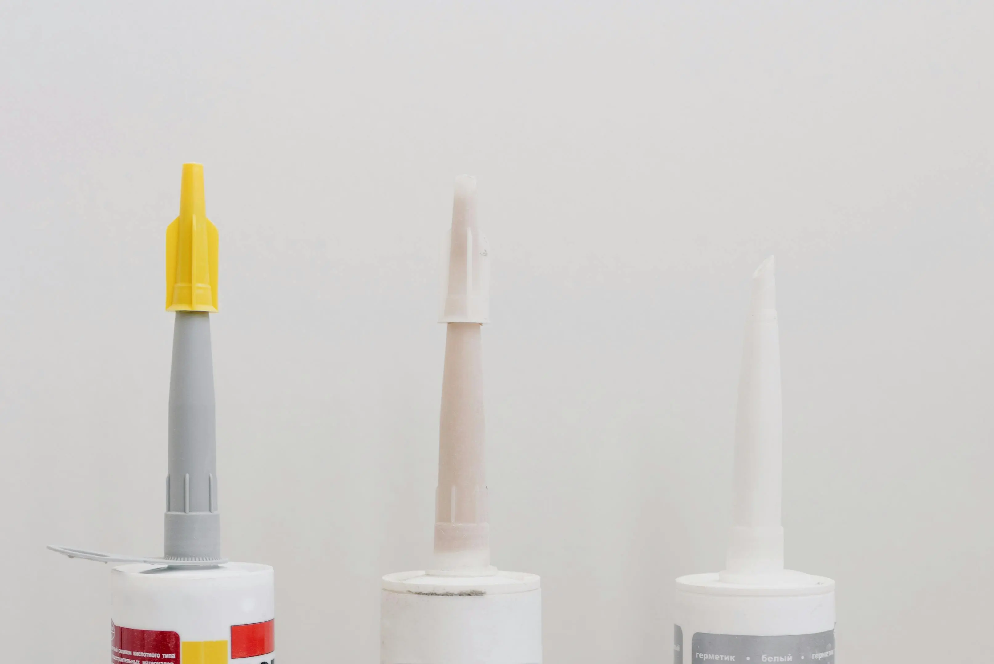 metal roof sealant Set of various plastic tubes with glue for renovation works in workshop against white background
