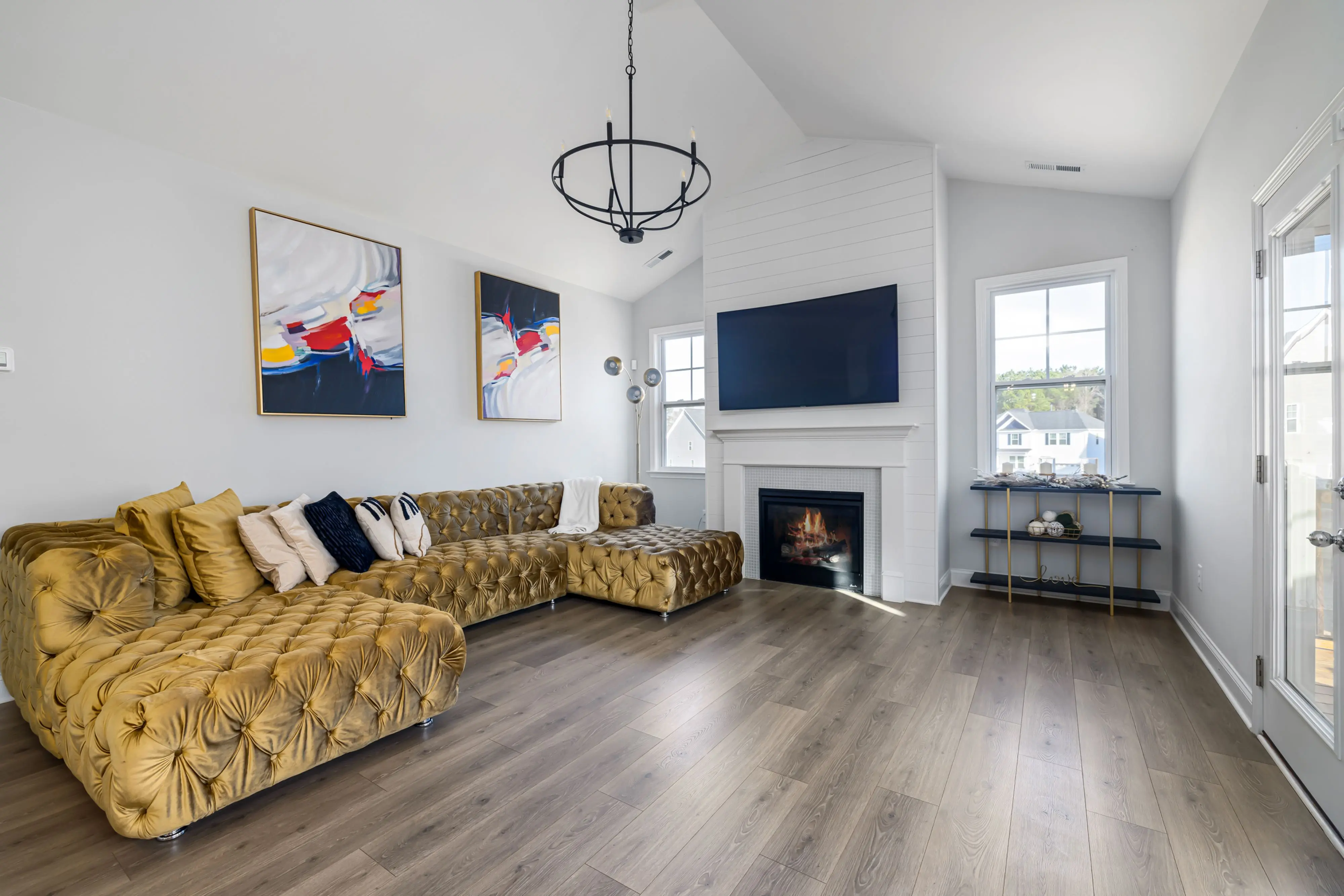 blue sectional sofa Spacious modern living room with elegant furniture, fireplace, and chic decor.
