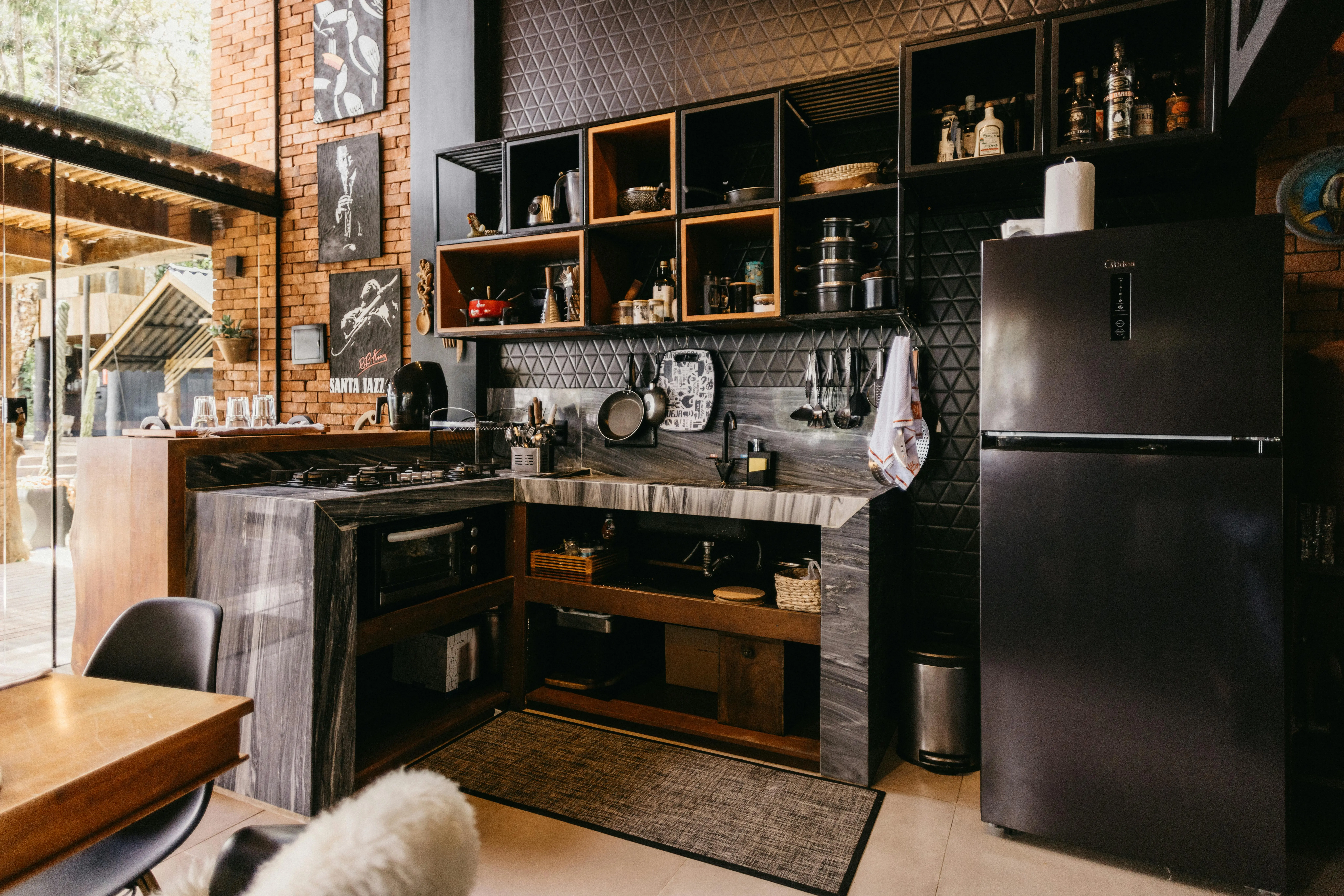 tiny home kitchen A stylish modern kitchen design featuring wooden accents and open shelving, perfect for home inspiration.