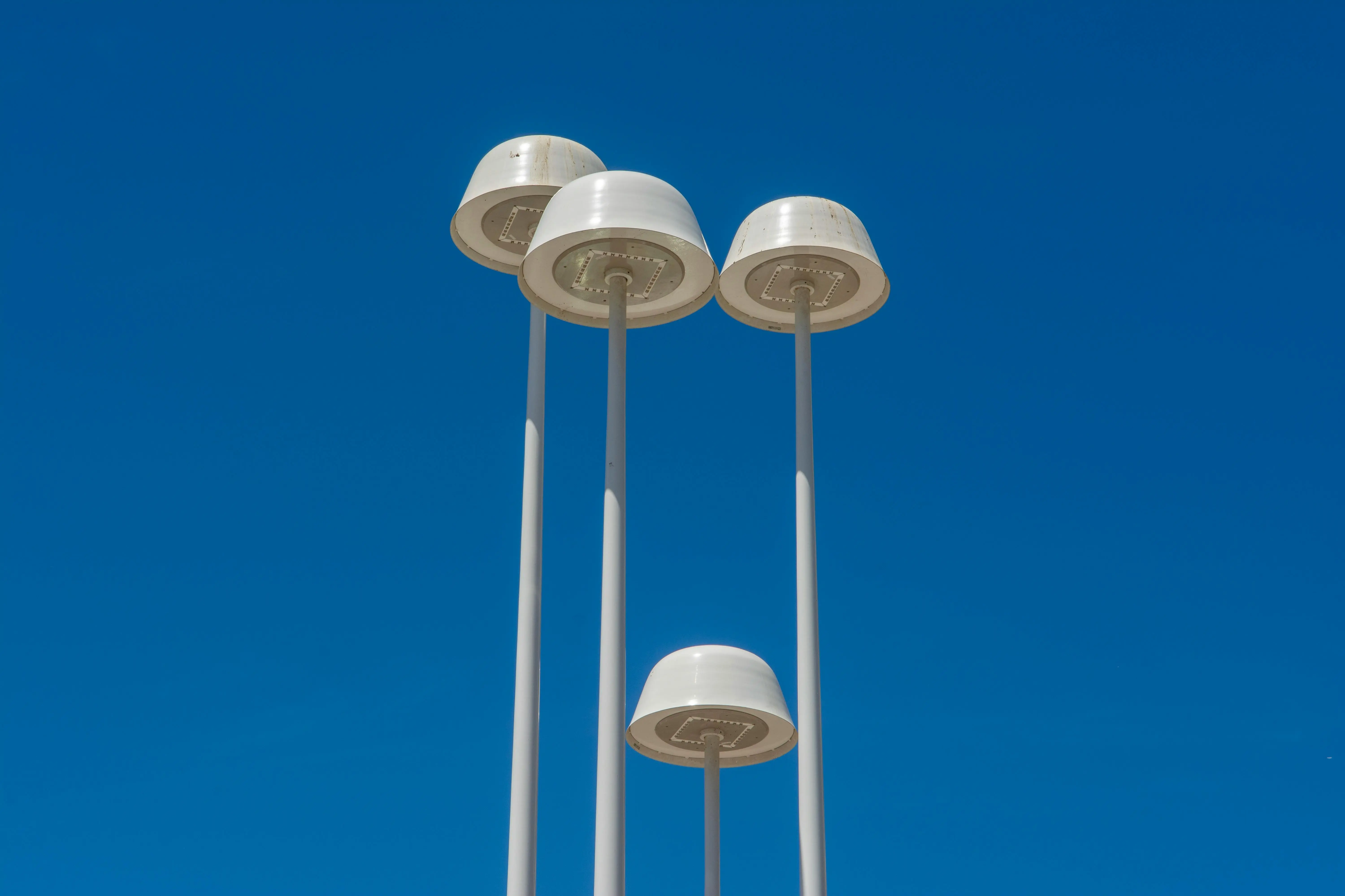 tall table lamps Minimalist street lamps set against a blue sky, showcasing urban design and architecture.