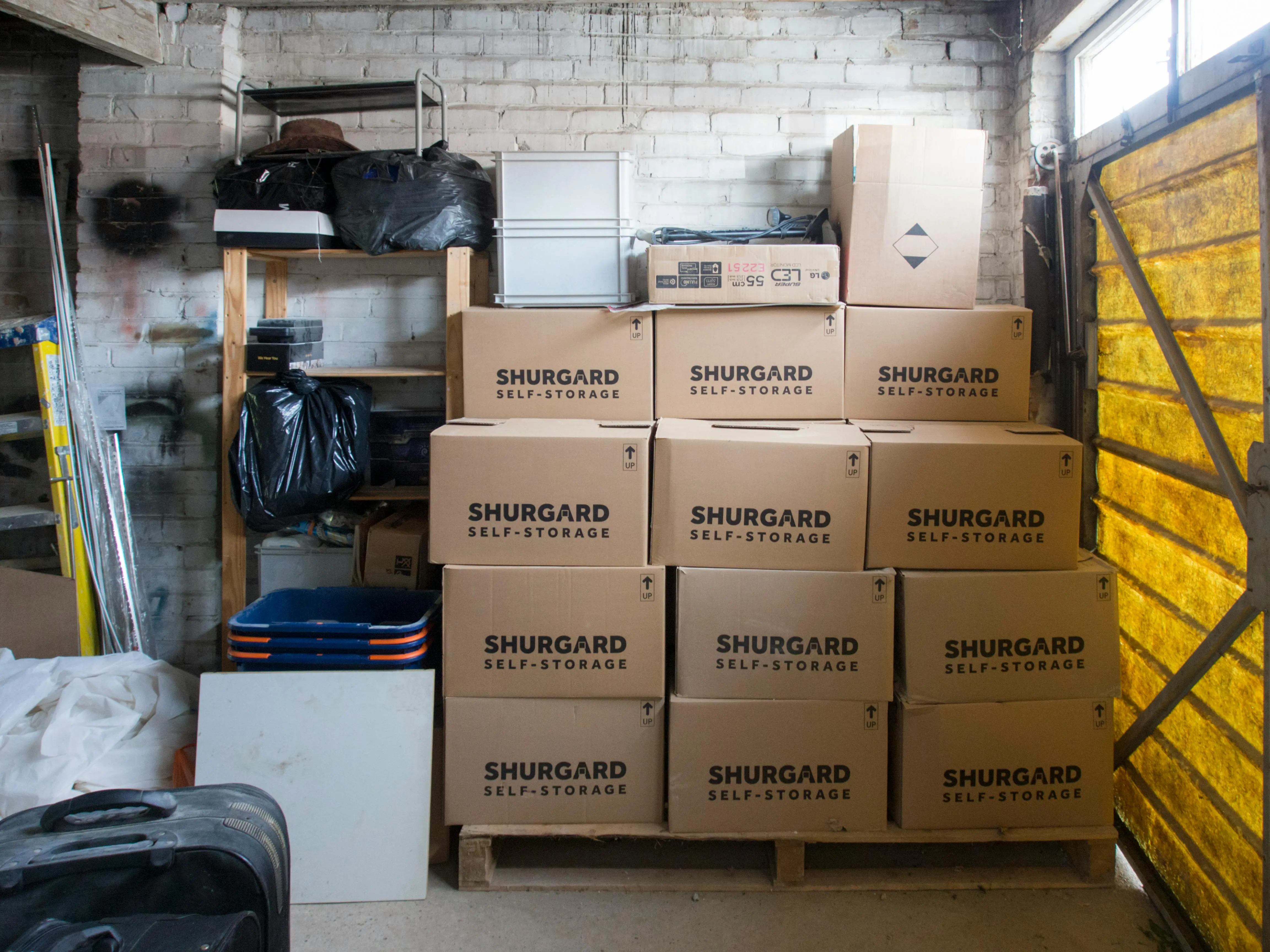 tiny home with 2 bedrooms A stack of storage boxes in a well-organized warehouse interior.