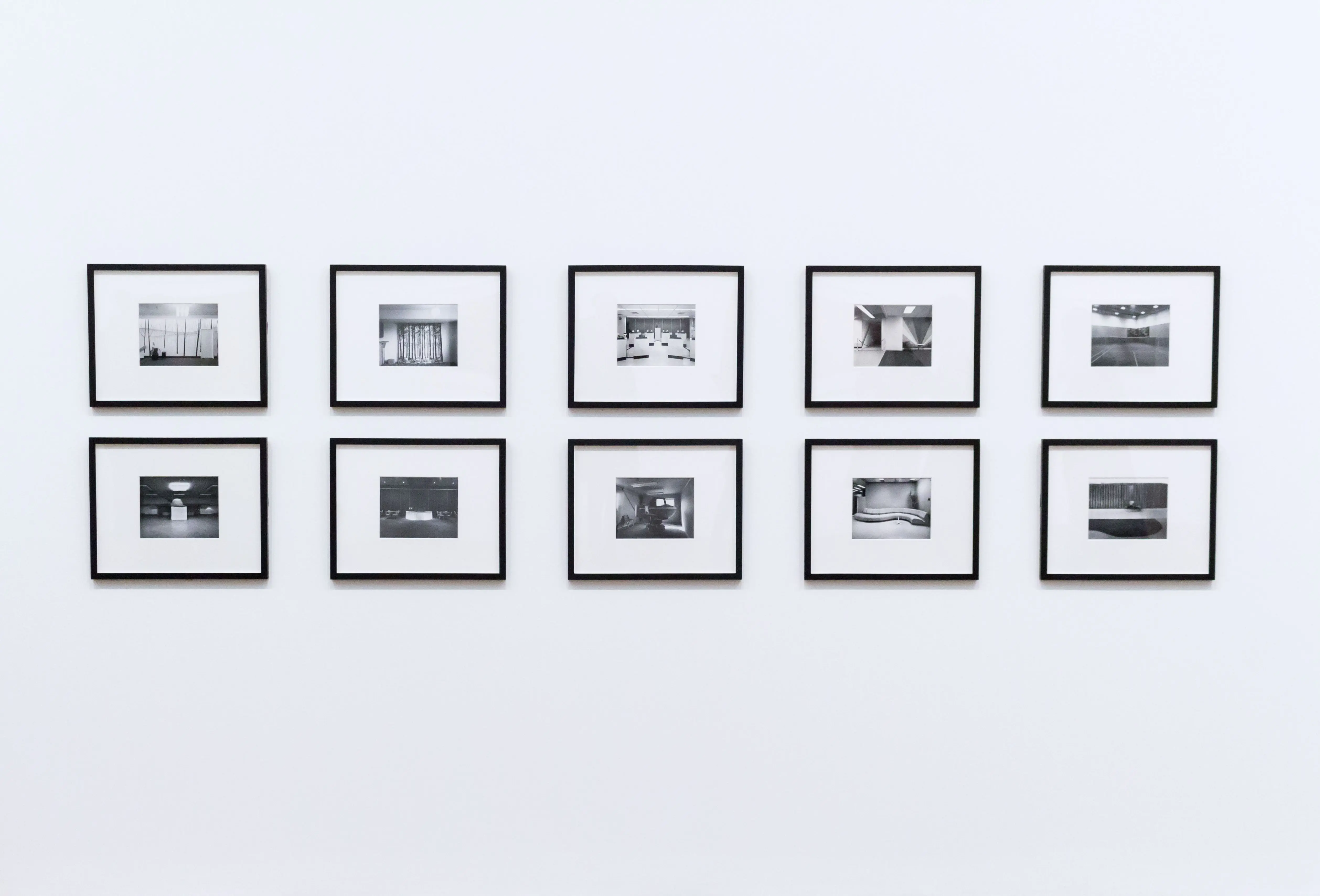wall sculpture Simple and elegant wall display with black and white framed photographs in a modern interior.