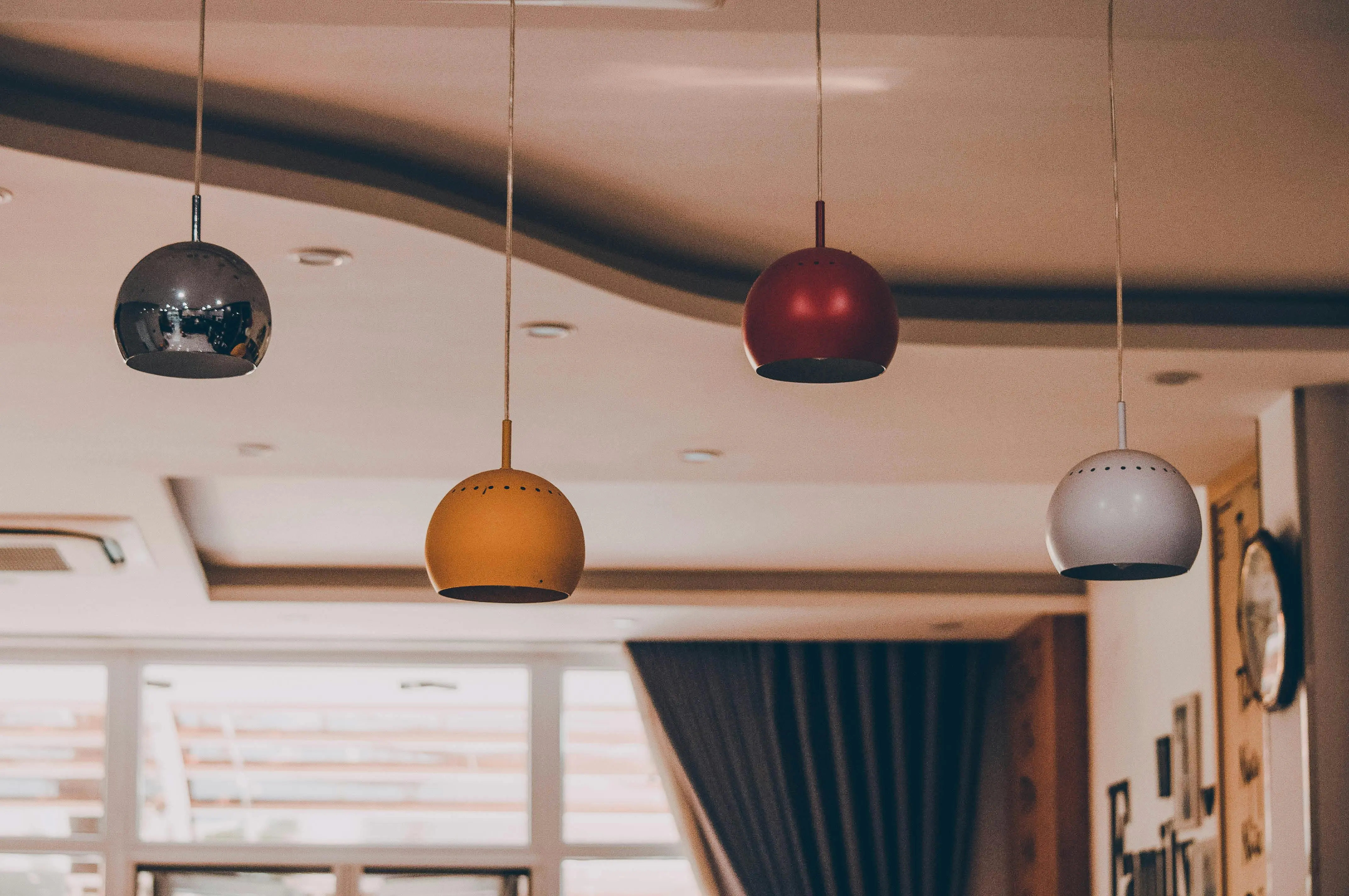 white lamp Modern interior with colorful pendant lamps and elegant ceiling design.
