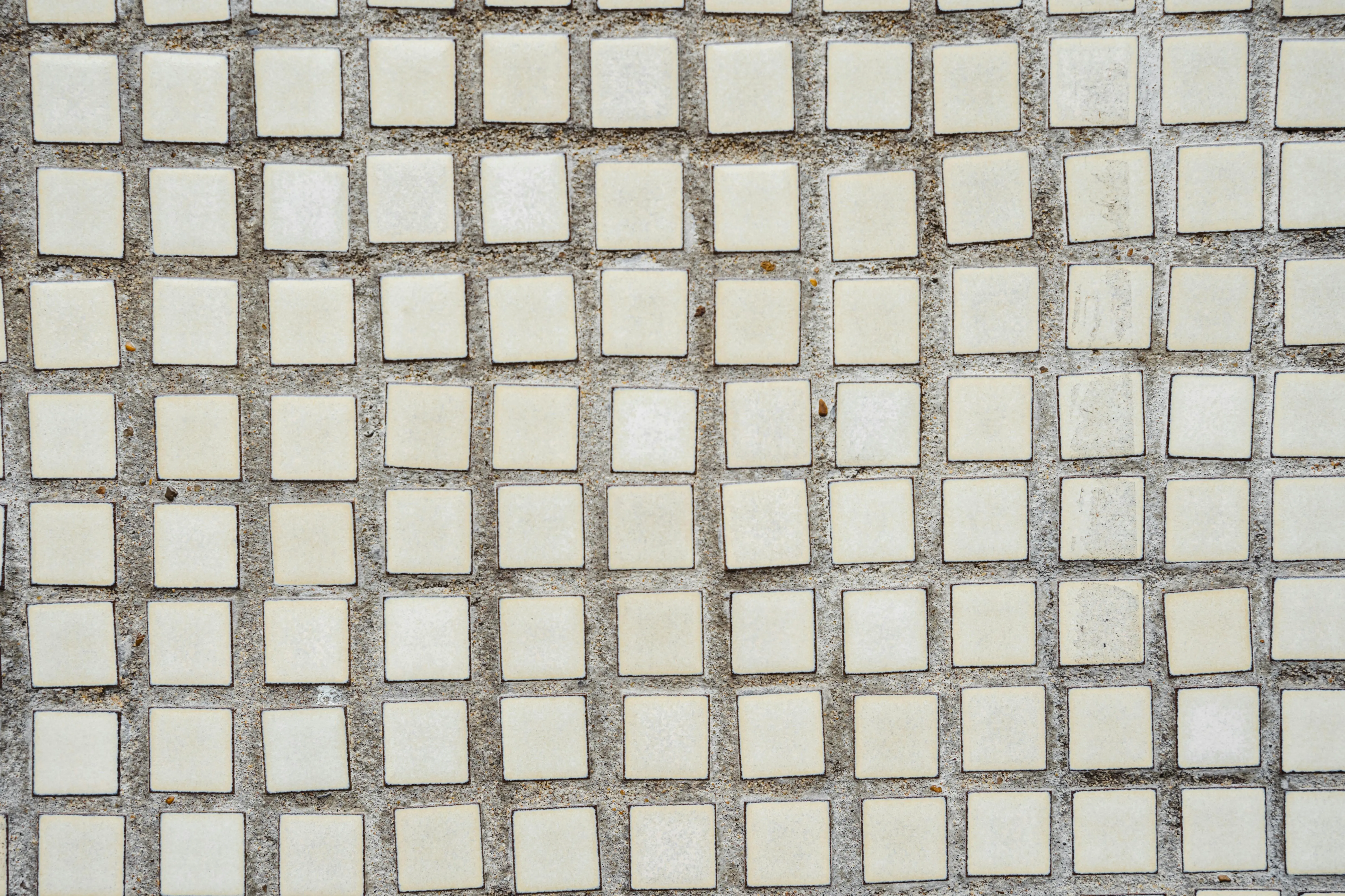 white tiles Aged urban building with white ceramic textured tiles in rows on street in daytime