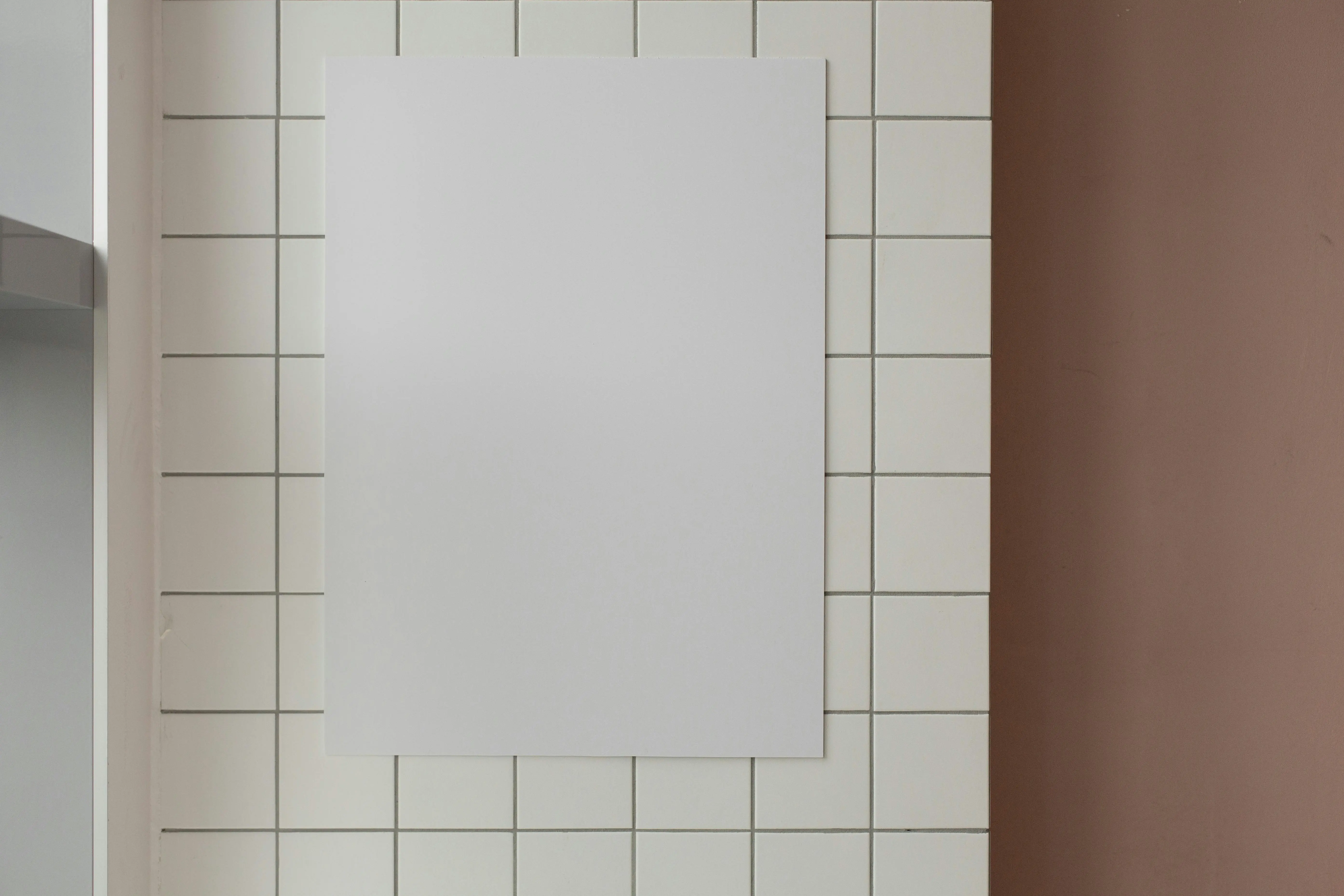 white tiles White mock up rectangular poster with copy space hanging on wall with tiles in light room in modern studio