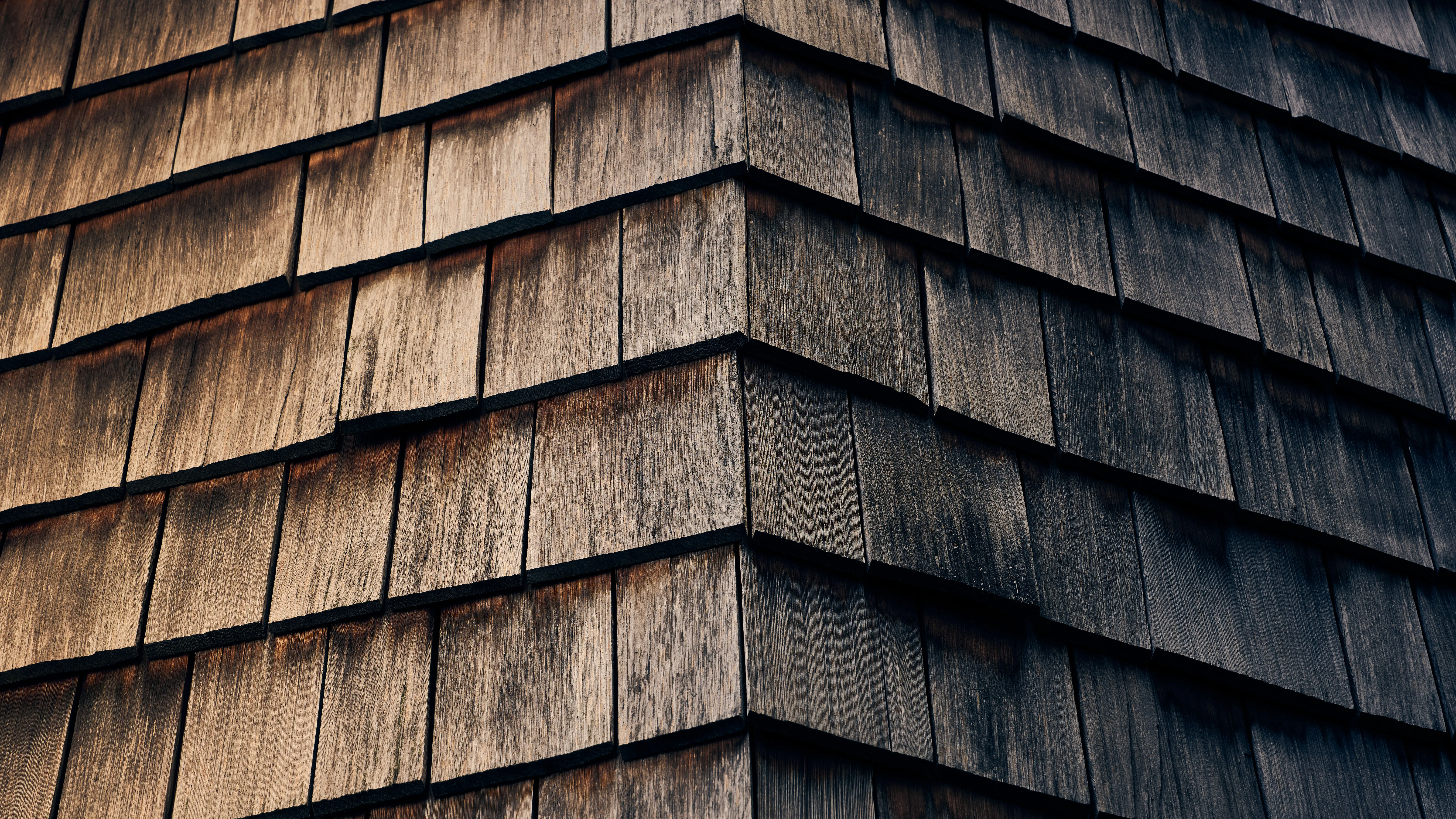 wood siding panels Detailed view of textured wooden shingles with a natural warm finish.