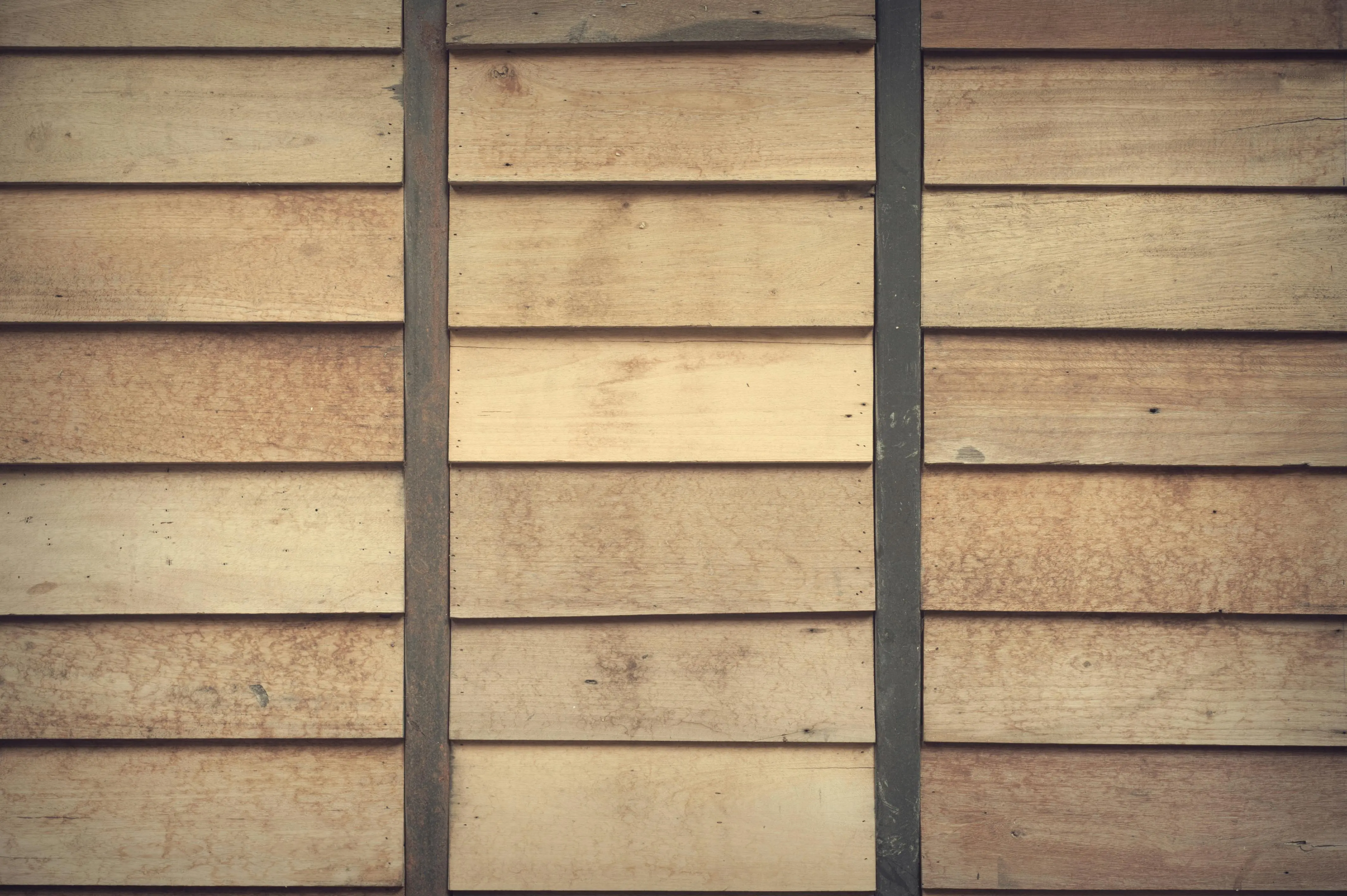 wood siding panels Close-up of light brown wooden wall with horizontal planks. Ideal for rustic decor or backgrounds.
