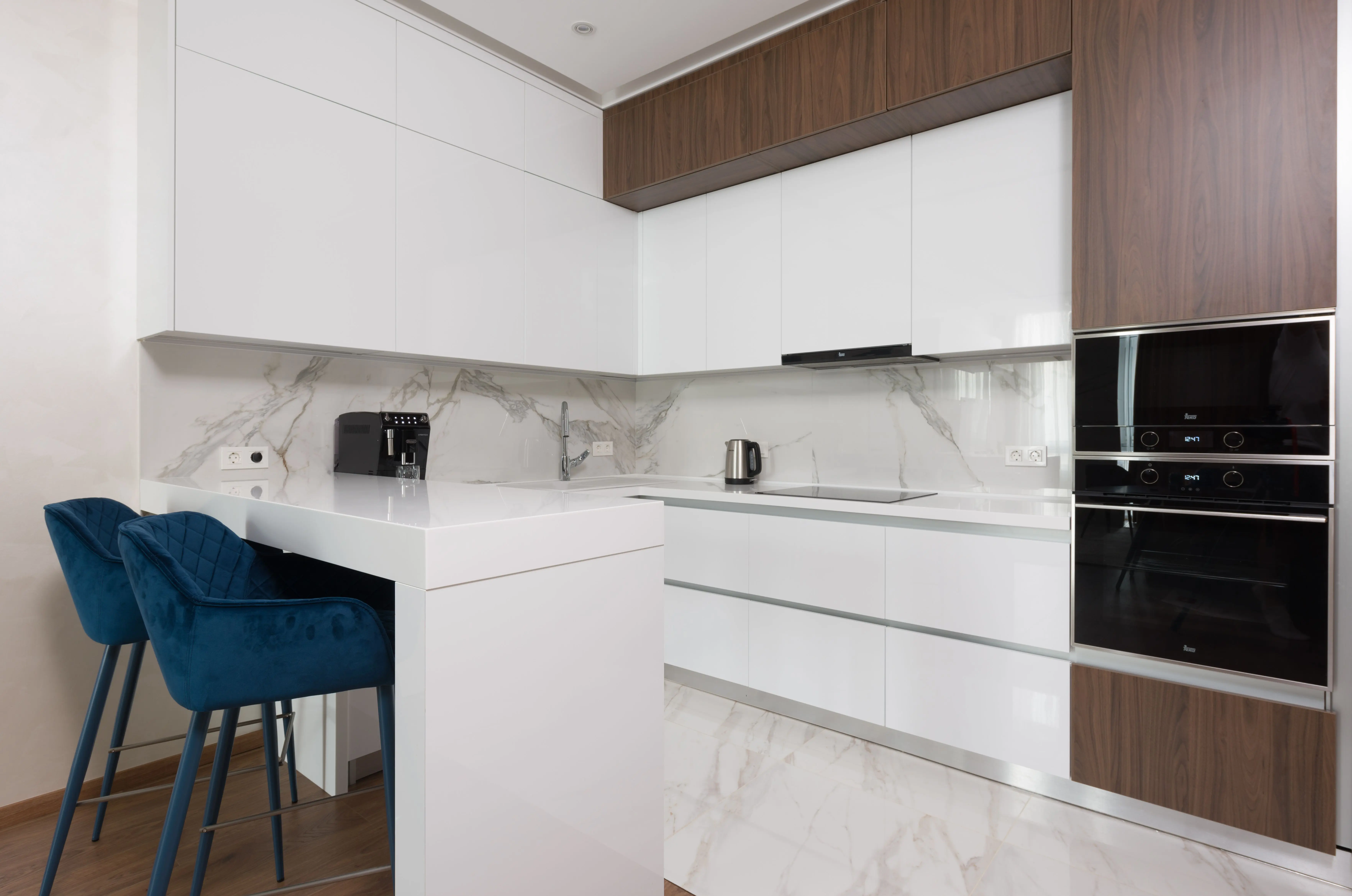 corner cabinets for kitchen Interior of light modern kitchen with chairs at dining table and appliances placed in modern apartment