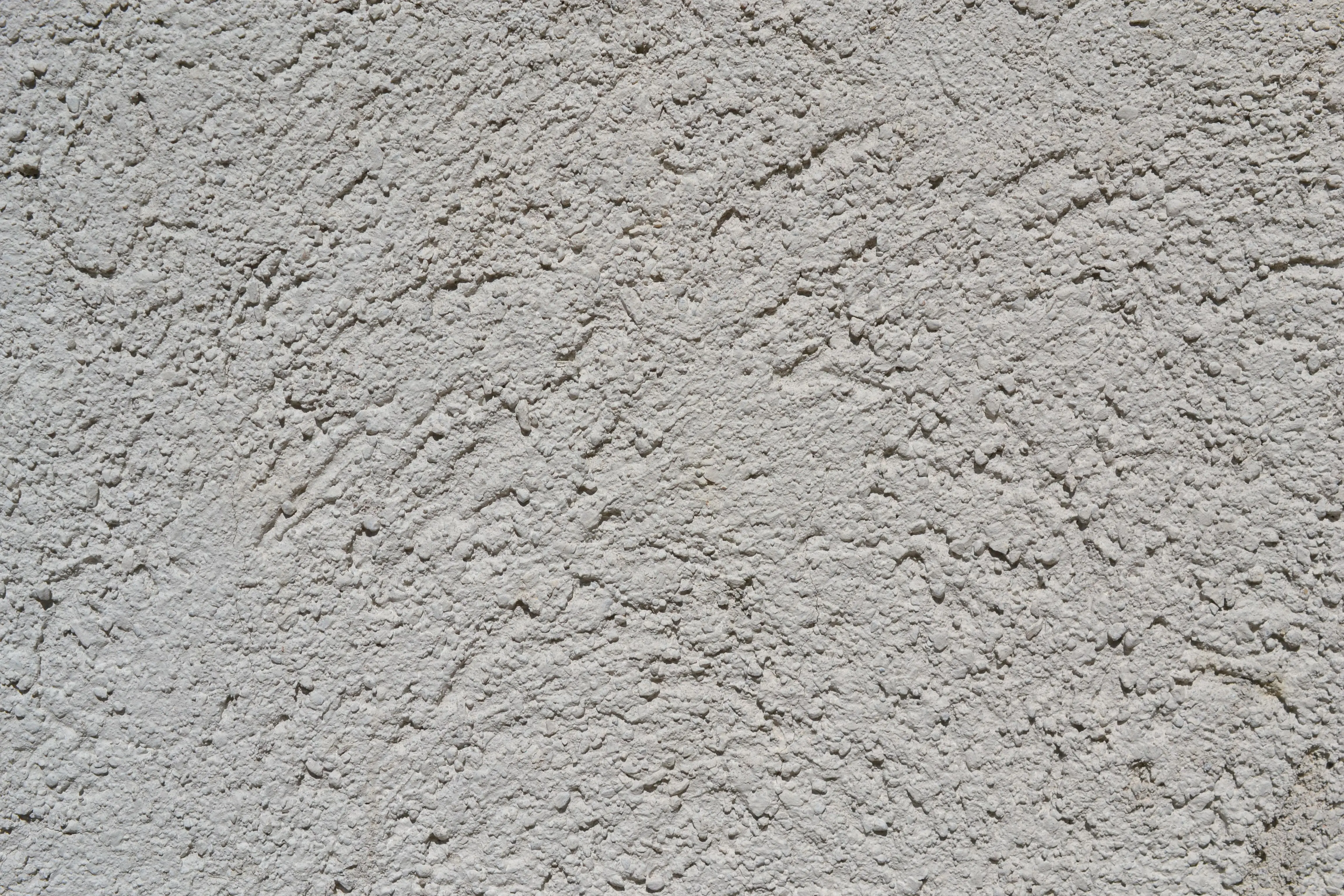 why make trims and doors satin paint Close-up of a light gray stucco wall texture, ideal for backgrounds.