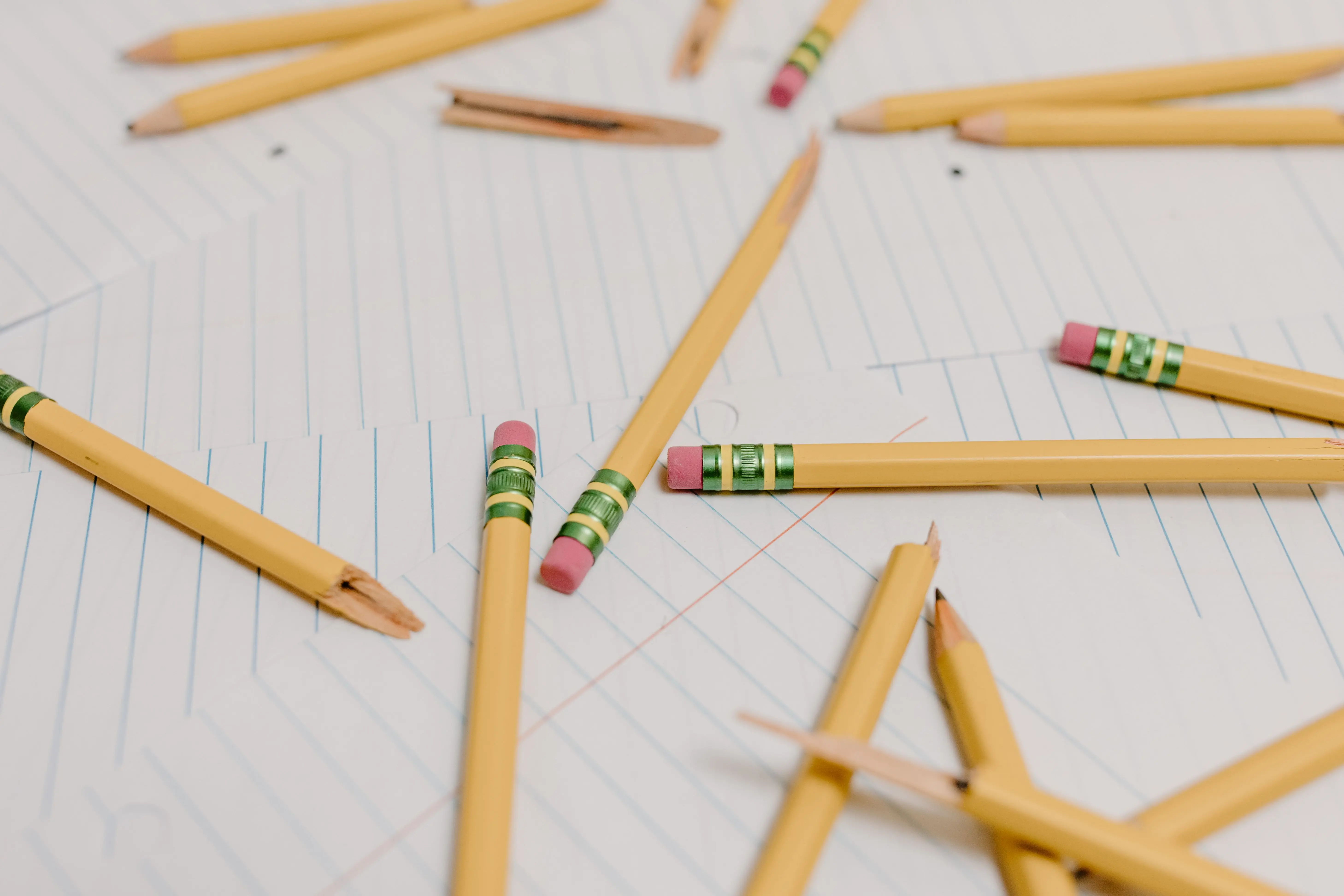 kids painting Several broken pencils scattered across lined paper, symbolizing burnout and overwork.