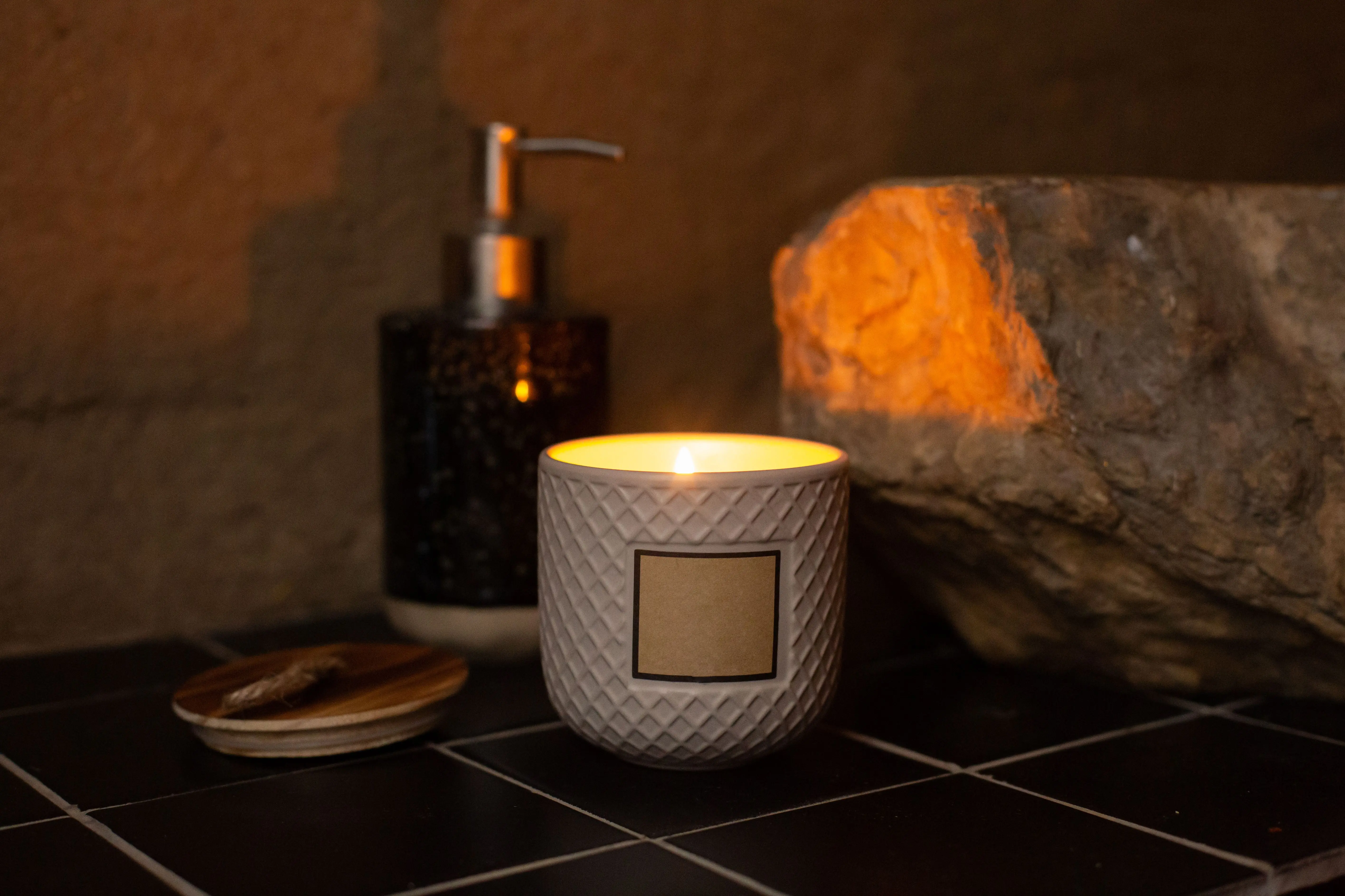 tall candle holders A calming scene featuring a burning candle and ceramic decor in a warm, illuminated setting.