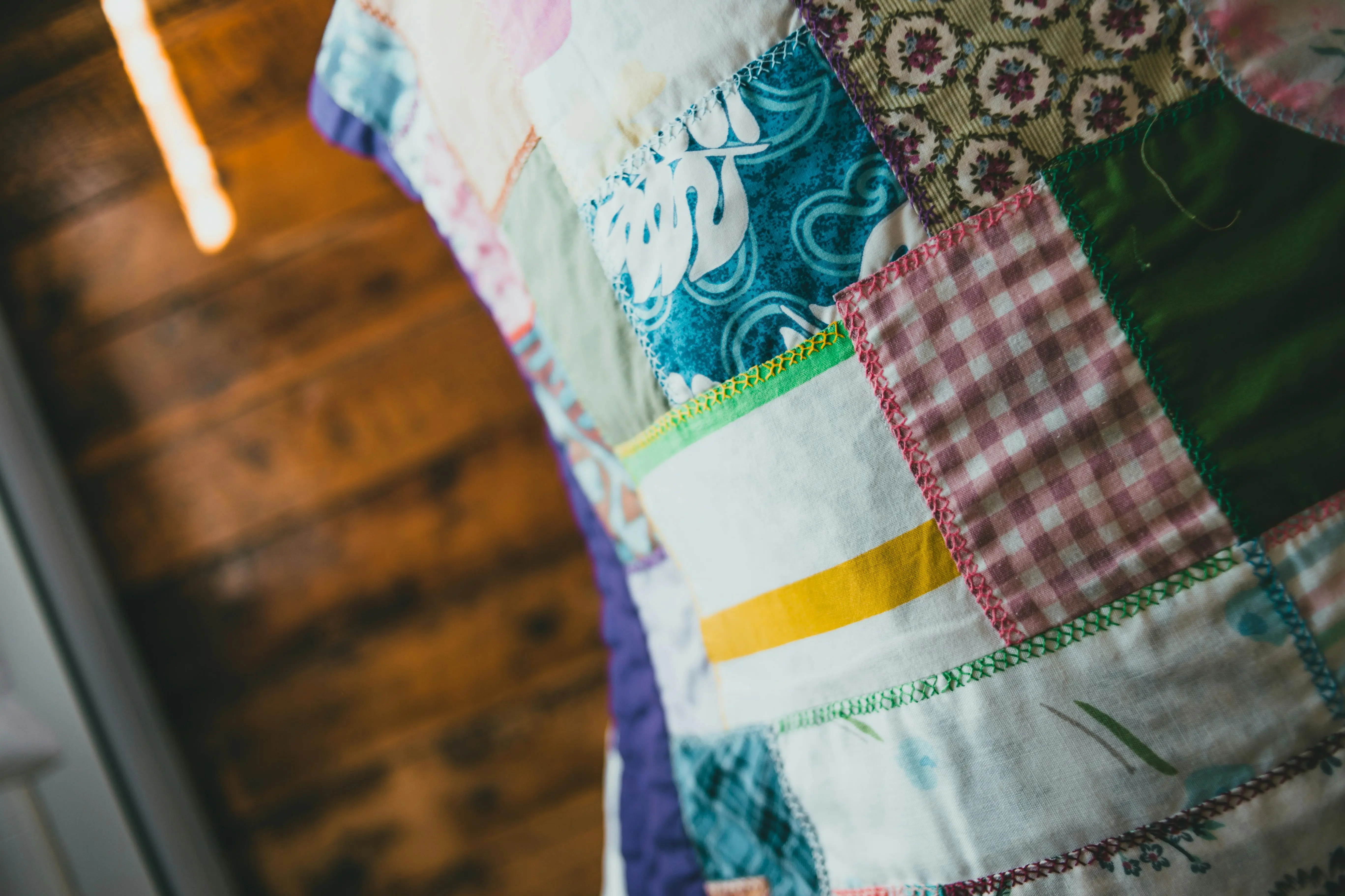 boho comforter set A close-up of a vibrant patchwork quilt showcasing various patterns and textures.