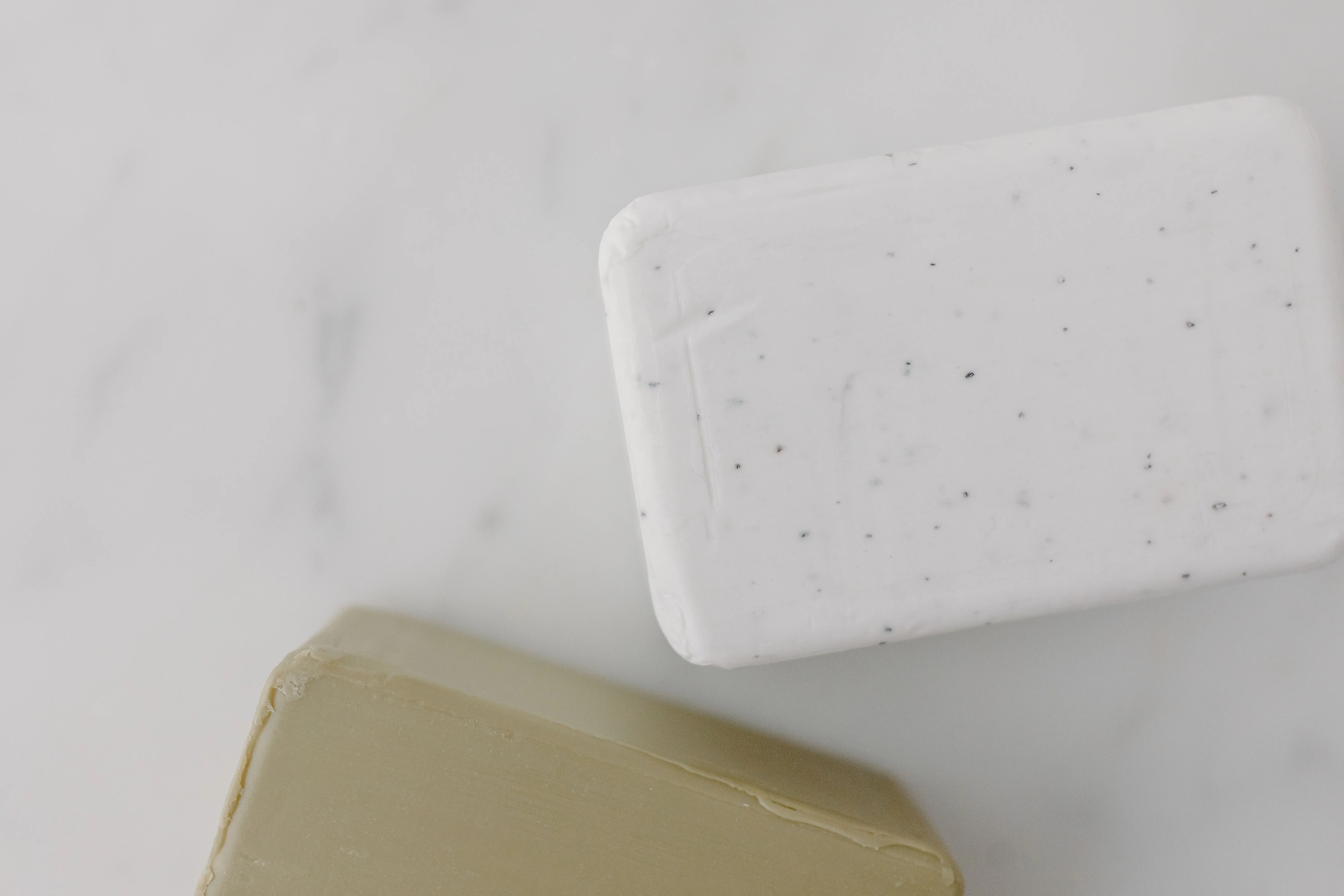 homemade laundry soap Elegant overhead shot of two soap bars on marble, perfect for skincare and hygiene themes.