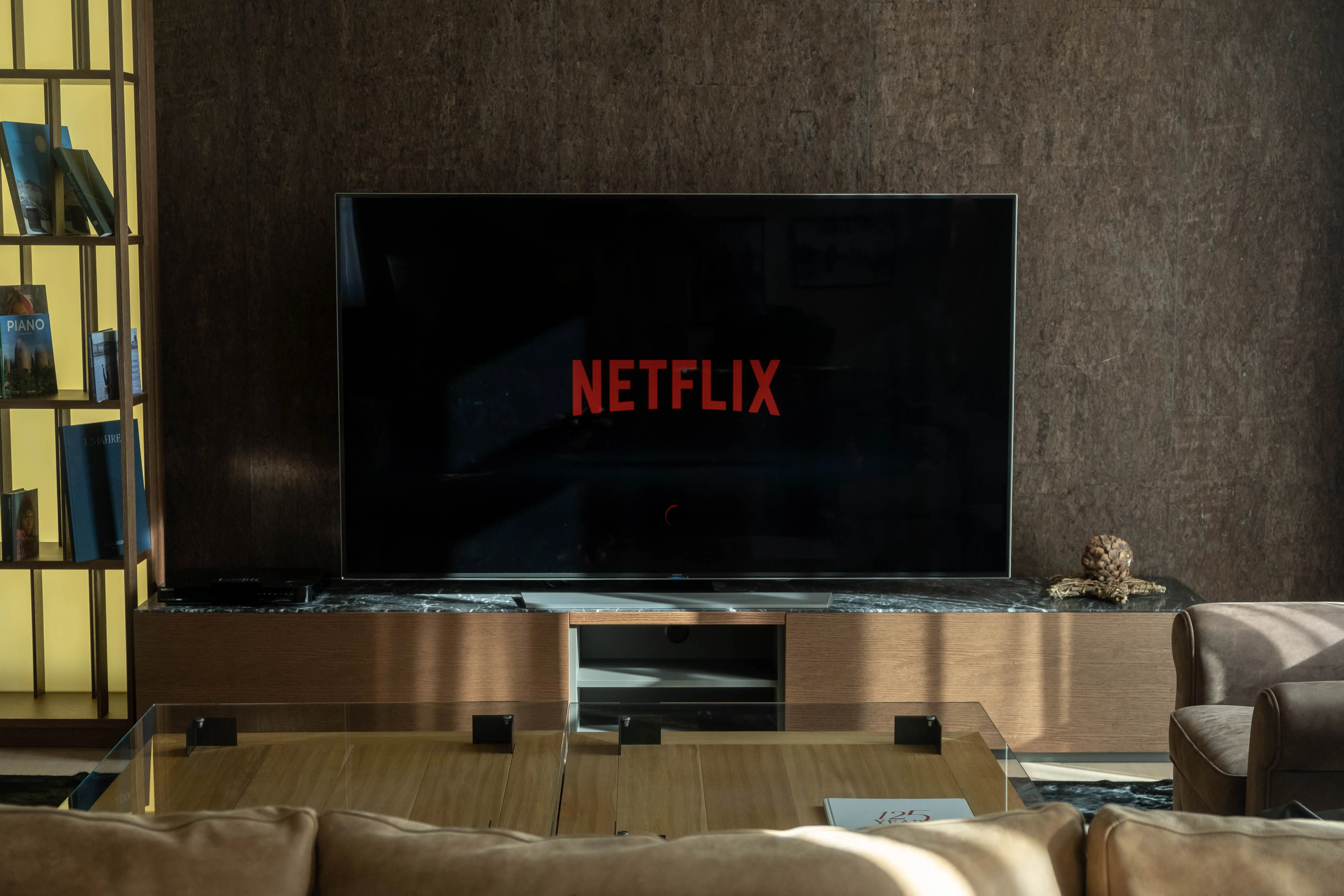 small living room ideas with tv Cozy living room featuring a large TV displaying Netflix, perfect for entertainment.