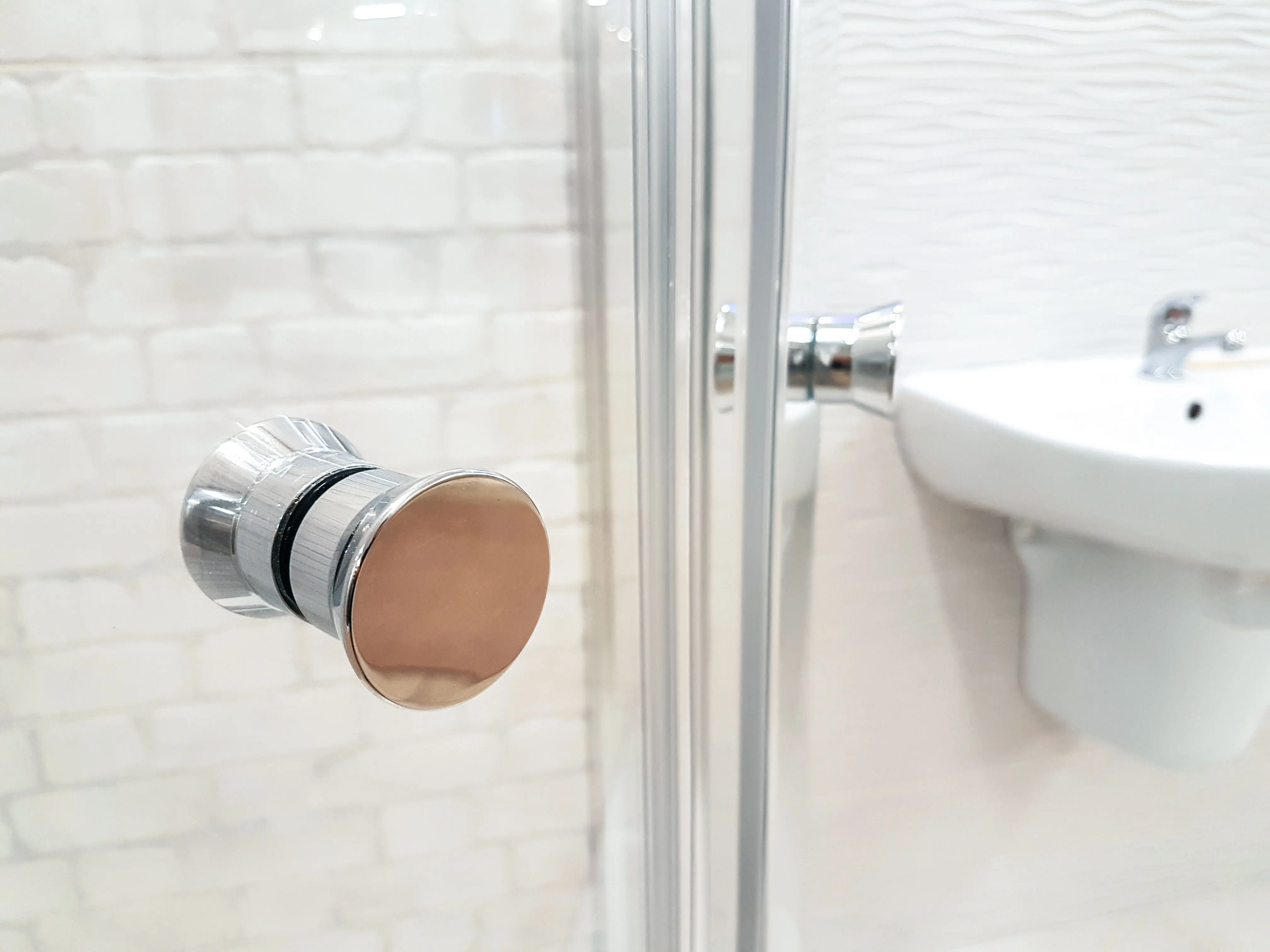 modern cabinet knobs Contemporary bathroom interior featuring glass shower and sleek sink design.