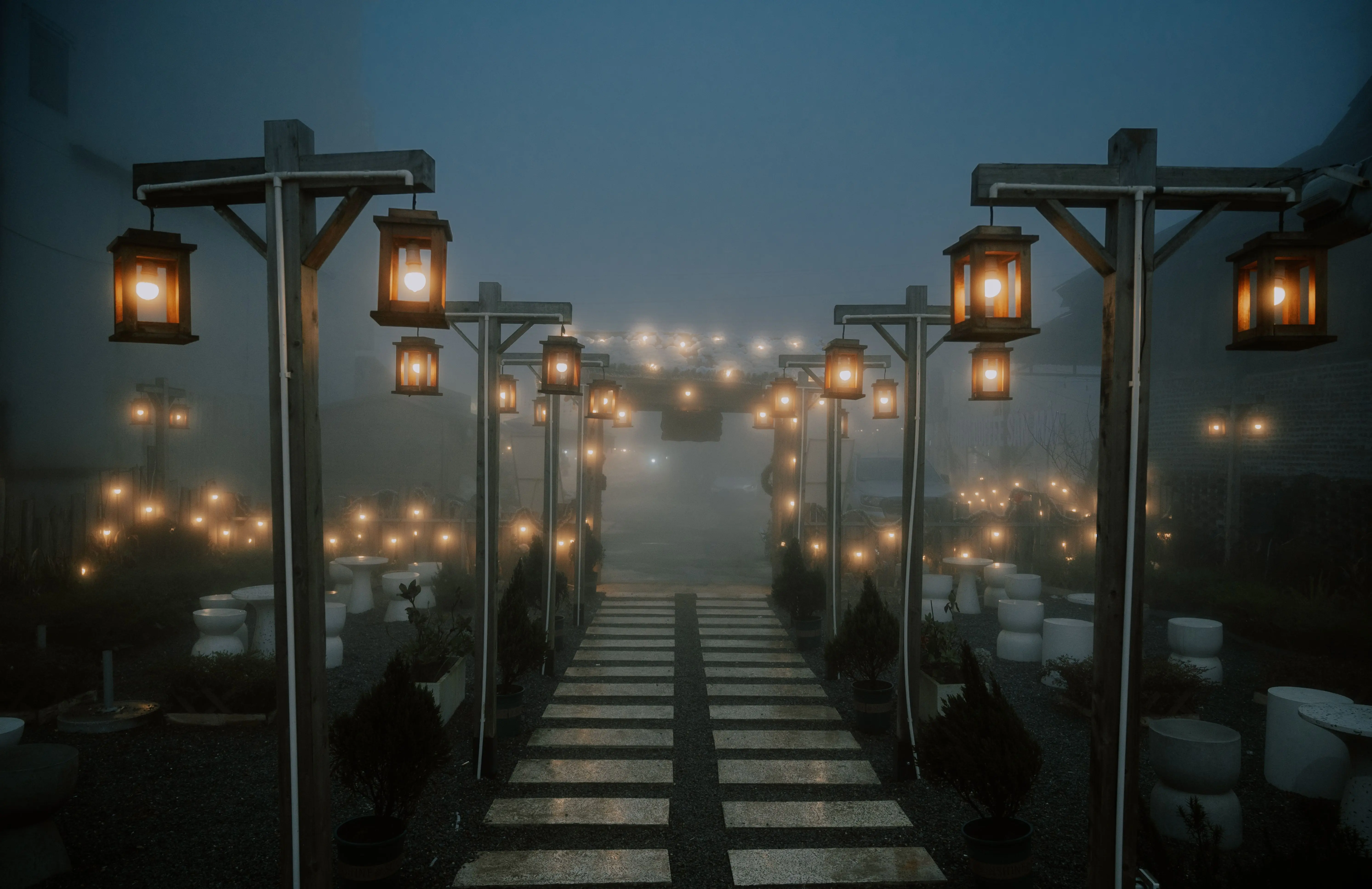 path lighting Enchanting misty pathway illuminated by lanterns at night, creating a serene and mystical atmosphere.