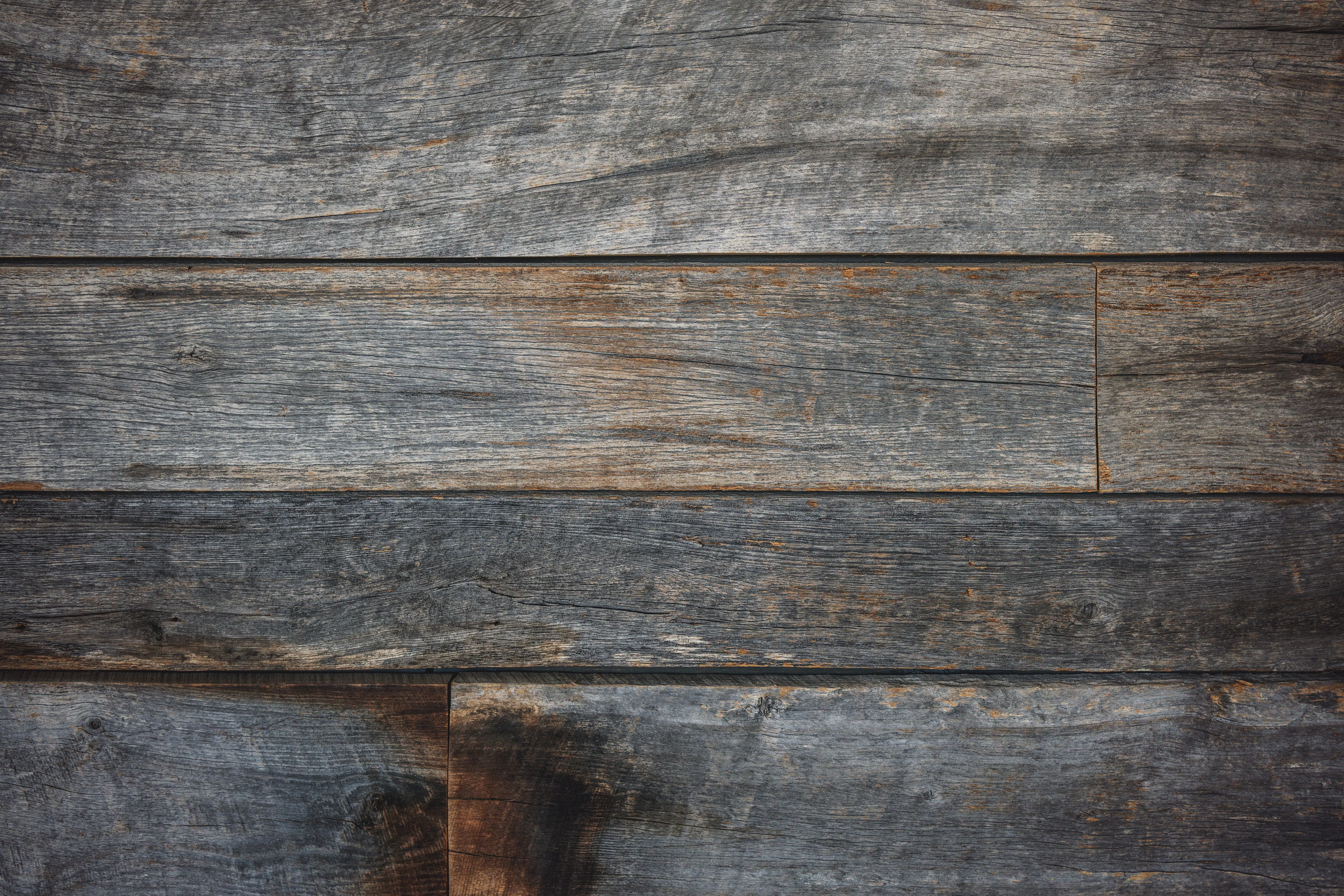 rustic wall decor Close-up of a rustic wooden wall with weathered planks, perfect for texture design.