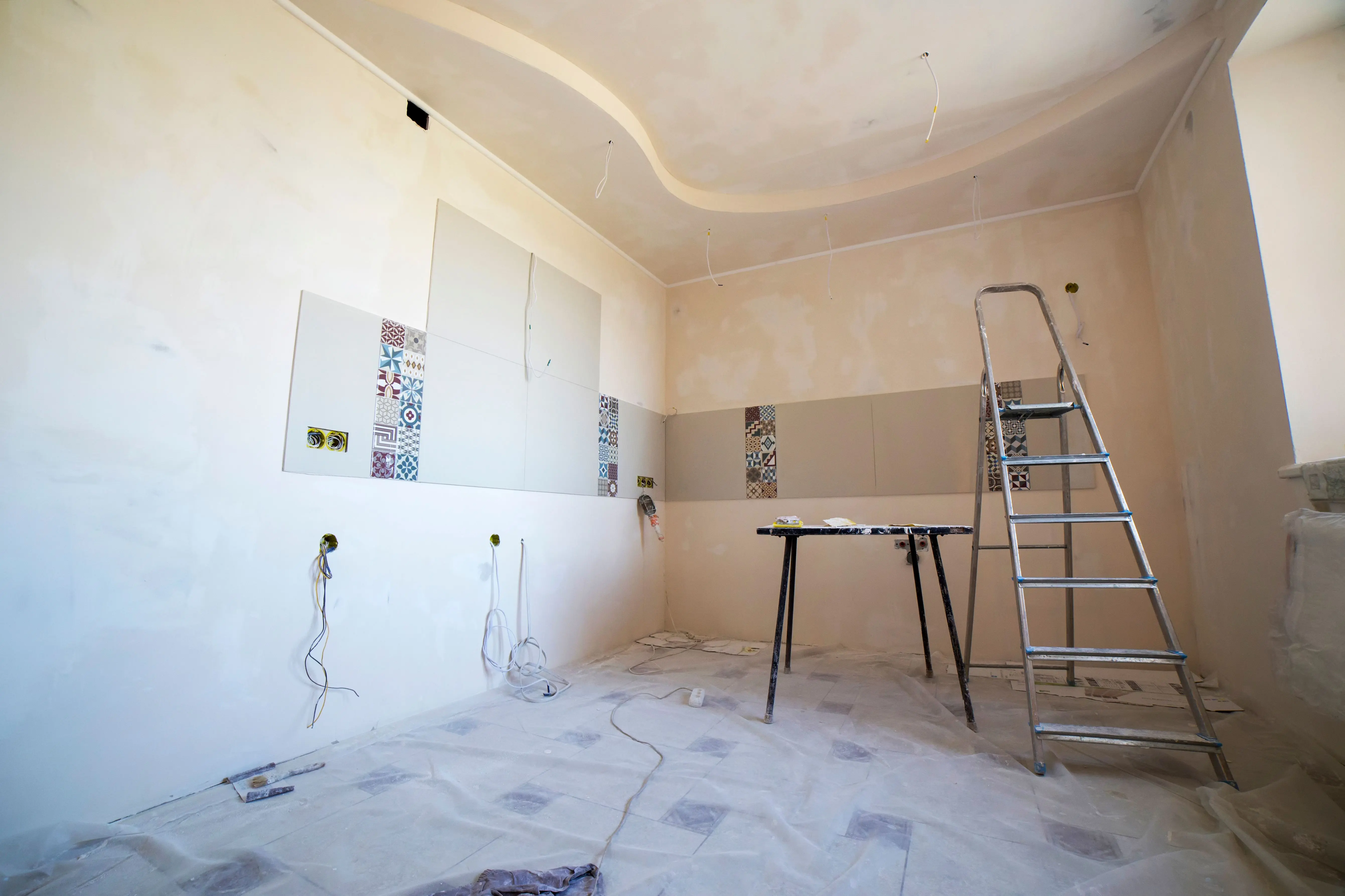 small living room ideas with tv Interior view of a room under renovation with paint, tiles, and tools.