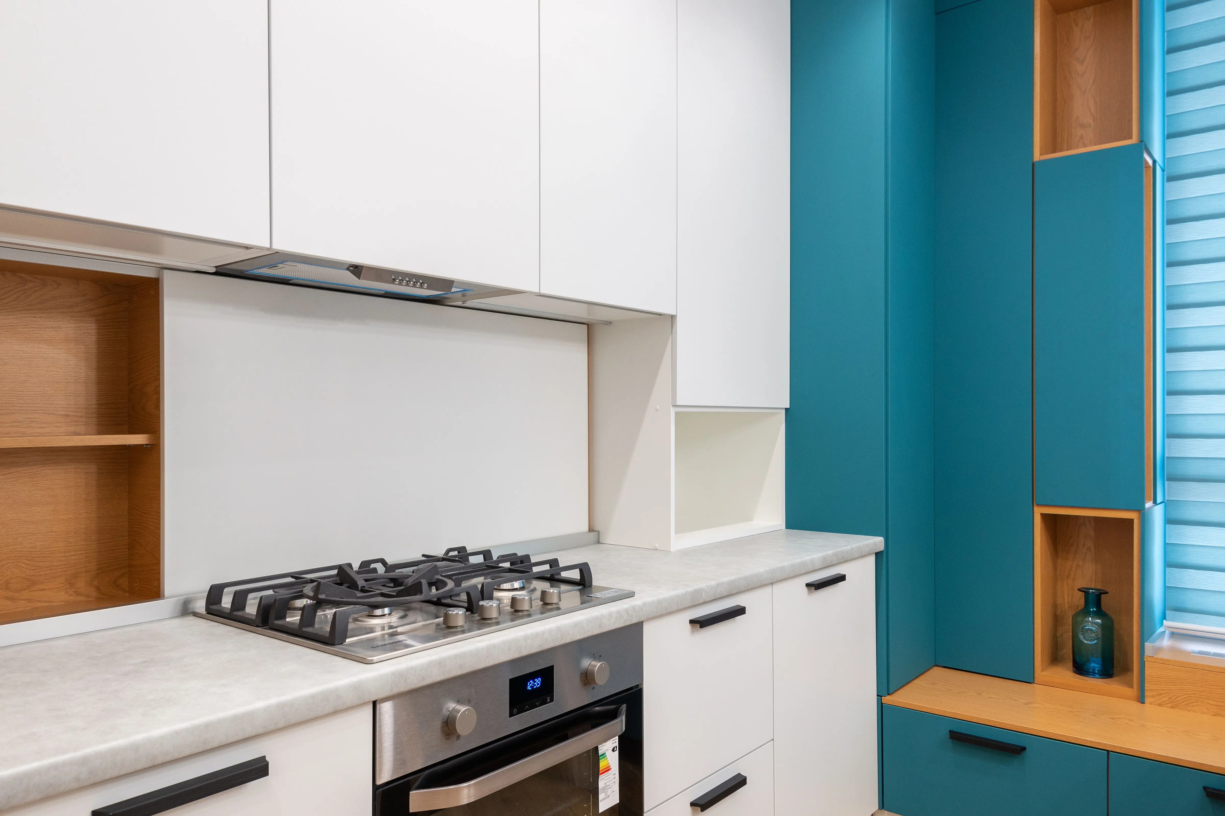 modern cabinet knobs White cabinet with gas stove and empty shelves against jalousie in contemporary light house