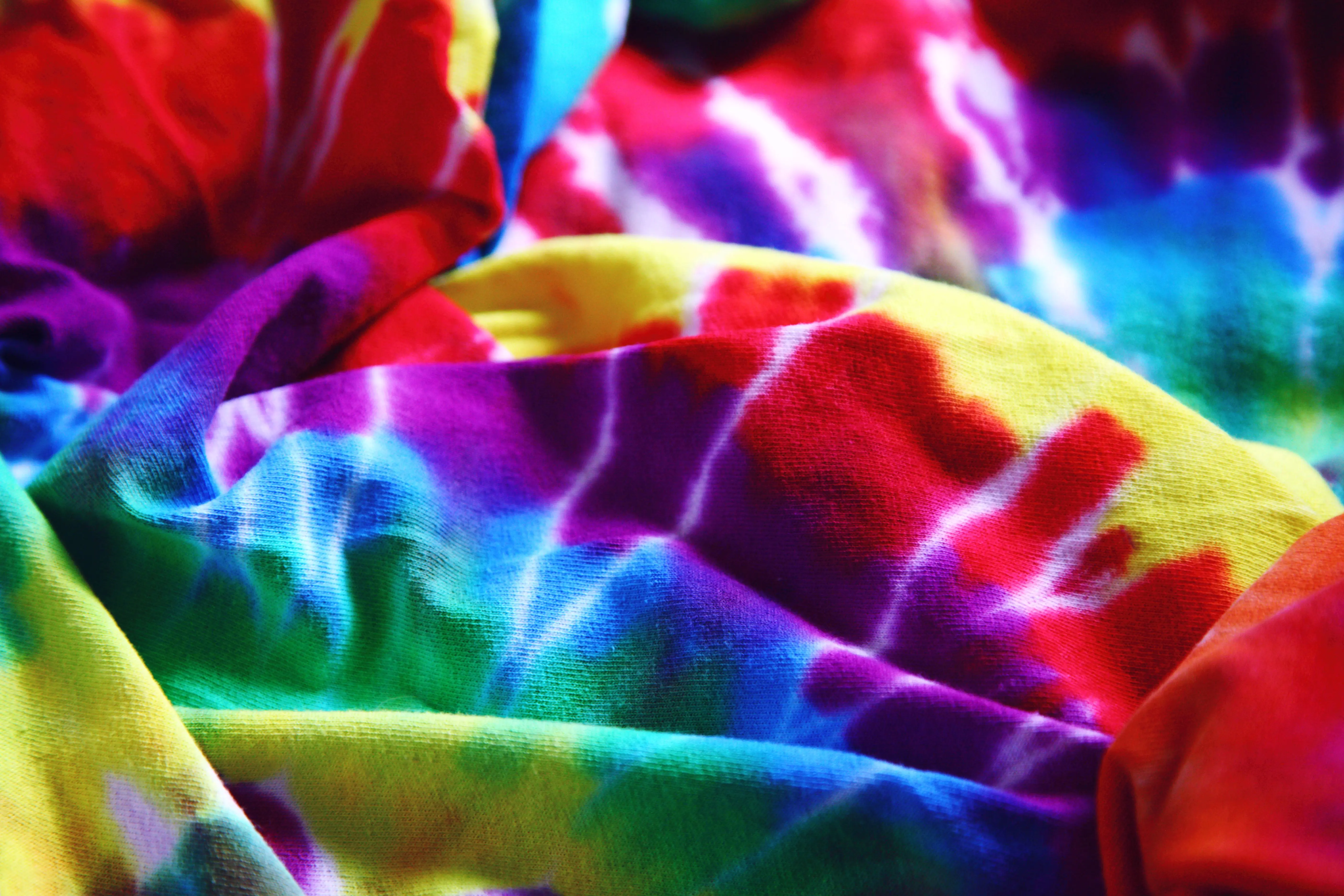 tie dye techniques Bright and colorful tie-dye fabric showcasing a rainbow spectrum. Perfect for designs and backgrounds.