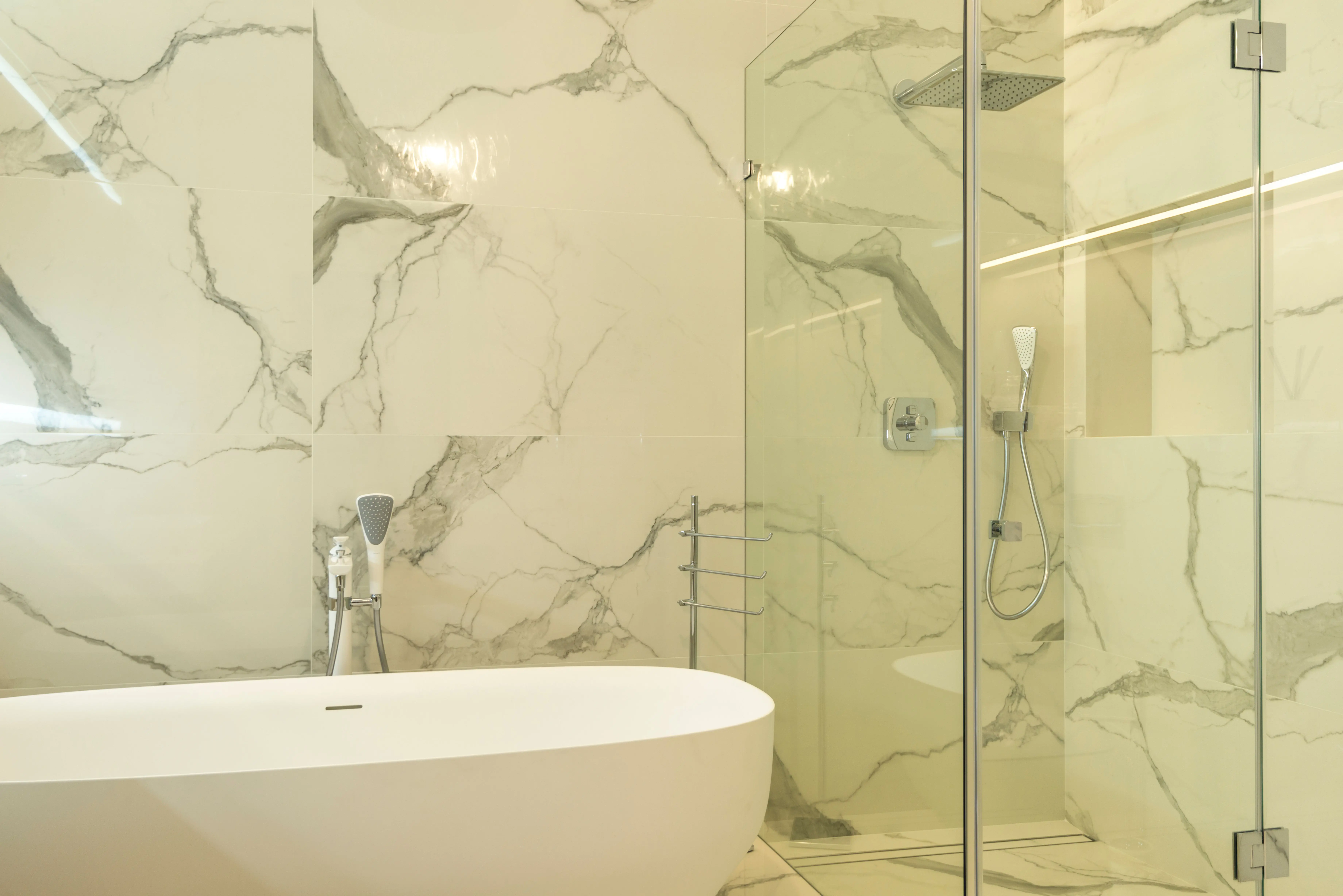 tile floor scrubber machine Luxurious marble bathroom featuring a modern bathtub and glass shower enclosure.