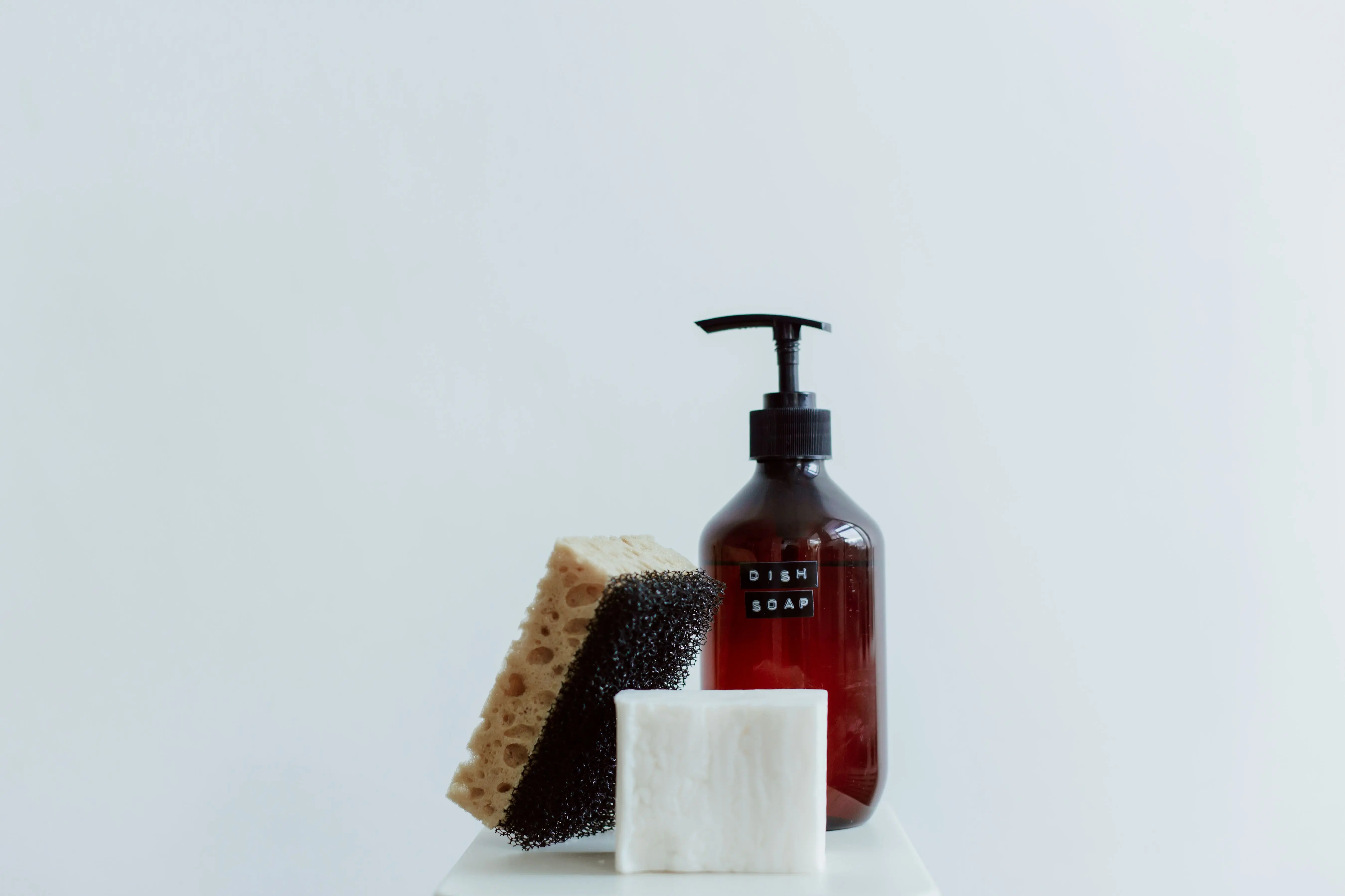 tile floor scrubber machine Stylish arrangement of dish soap, sponge, and bar soap in a minimalist setting.