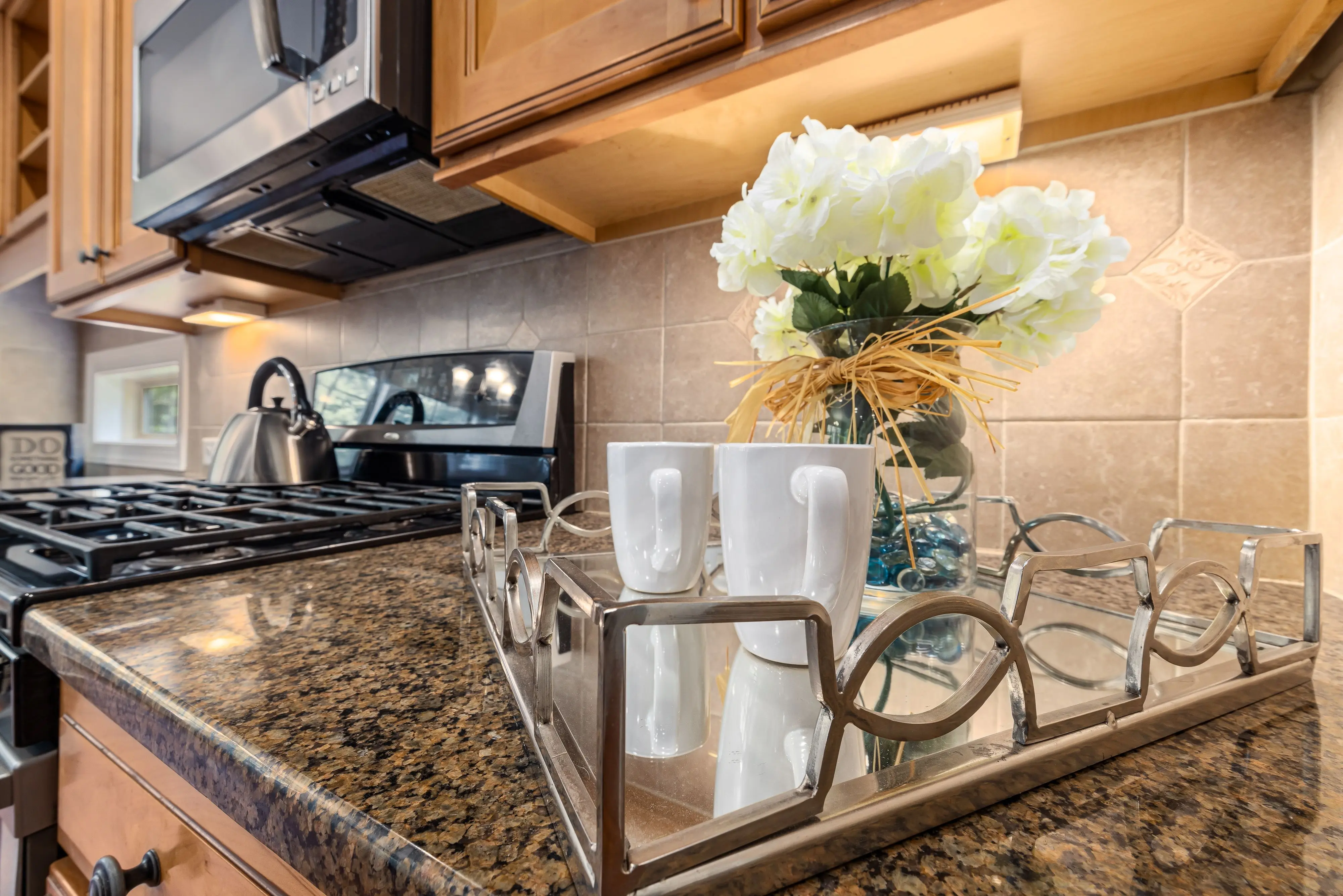 white kitchen backsplash Contemporary kitchen with granite countertops, stainless steel appliances, and decorative elements.