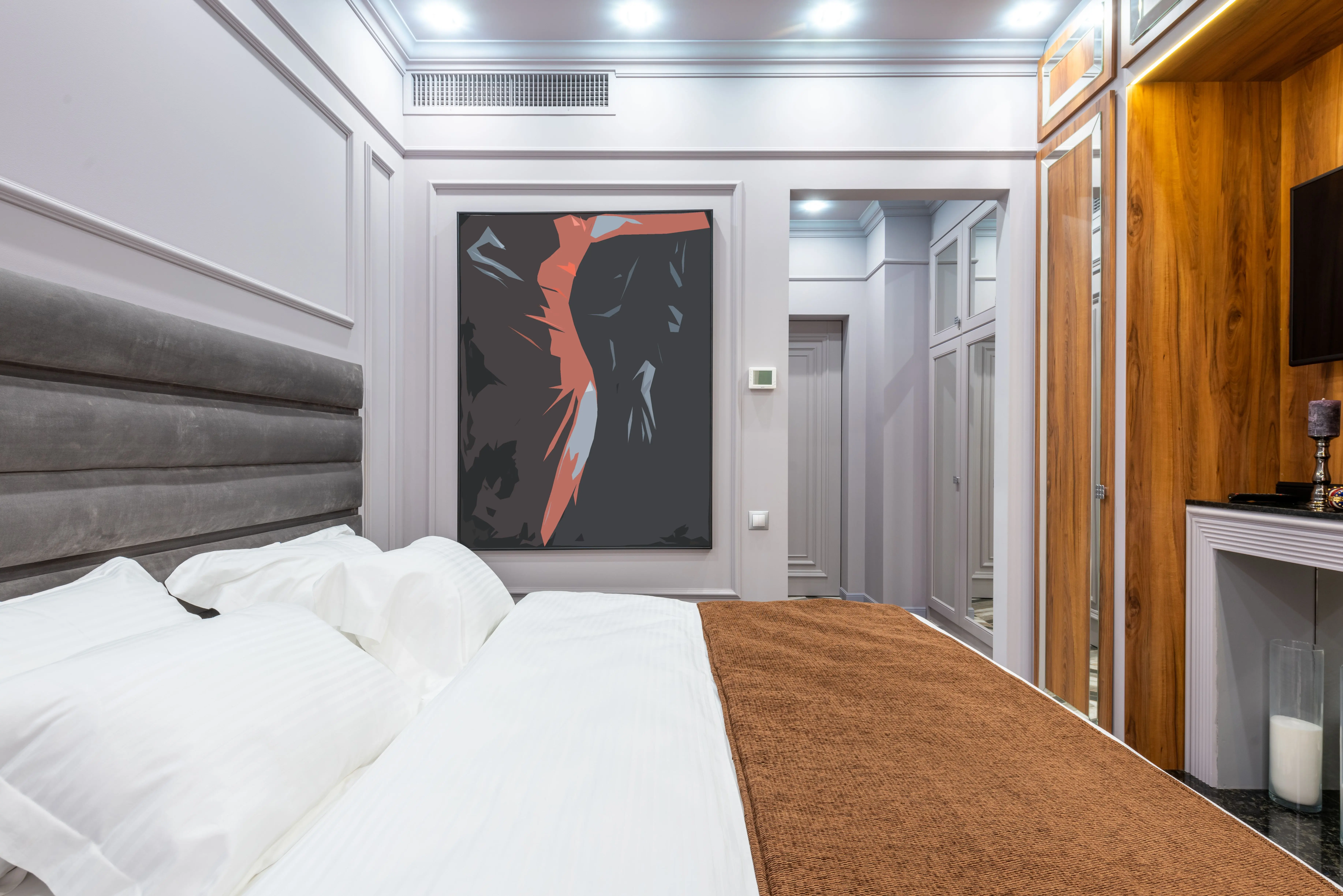 bedroom art Contemporary hotel room interior with pillows and cover on bed against artwork on wall and light corridor