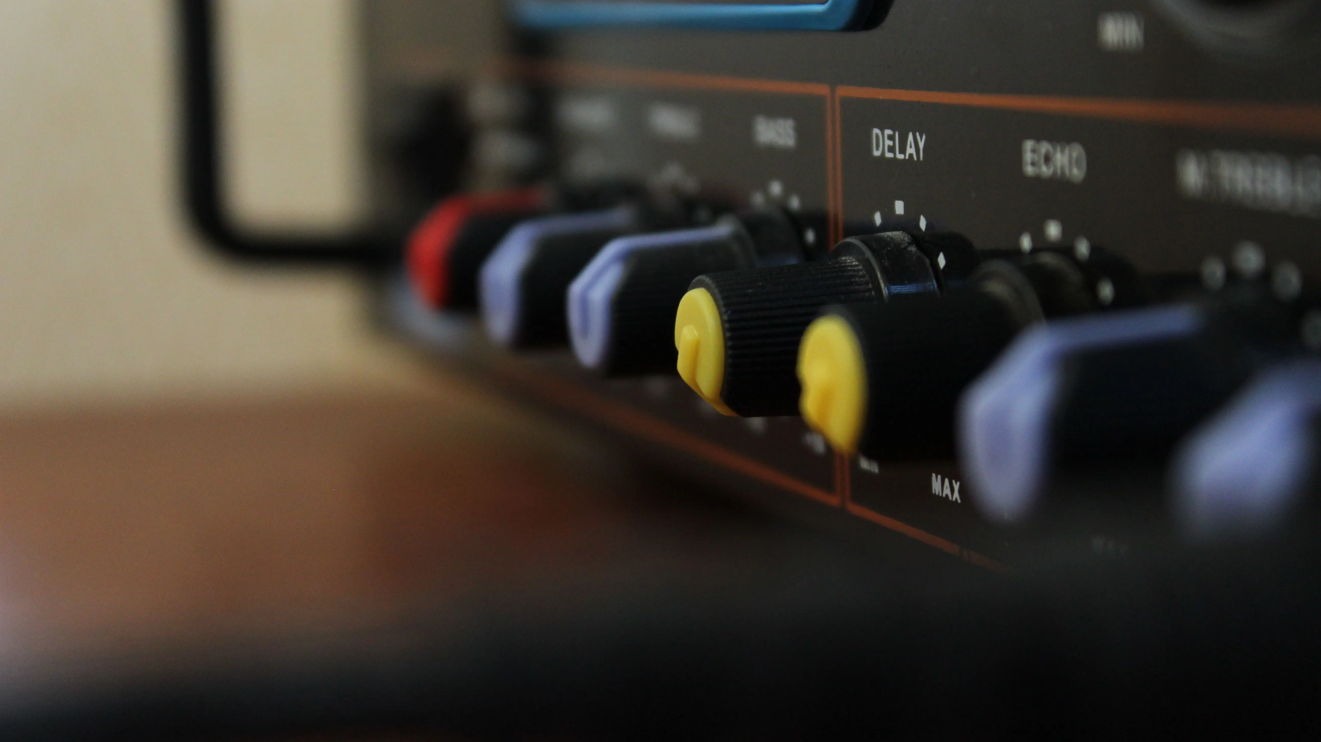 black cabinet knobs Detailed view of colorful control knobs on audio equipment showcasing modern technology.