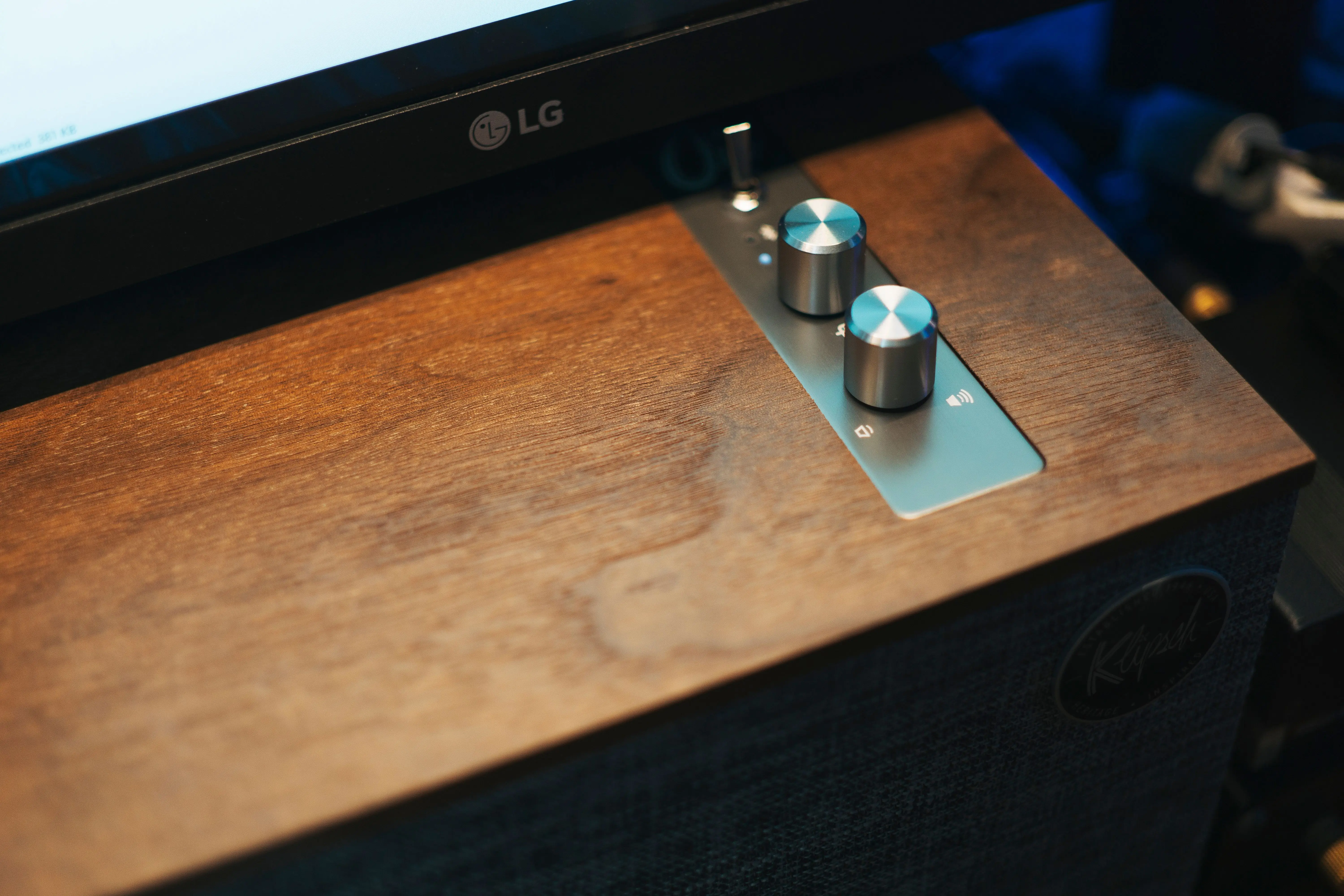 unique cabinet hardware Close-up of a modern audio control panel with knobs on a wooden surface, ideal for sound setups.