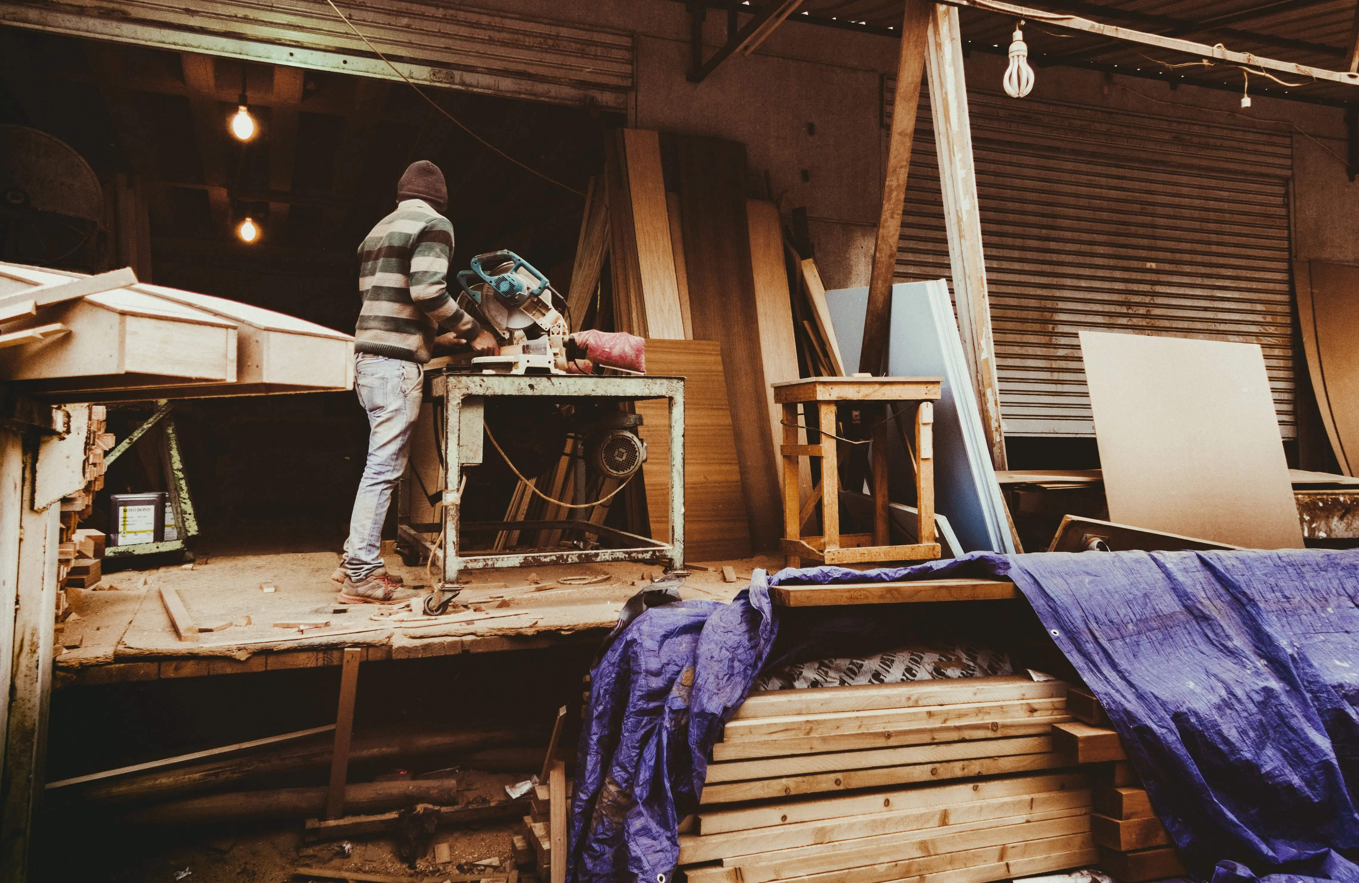 frame wood Carpenter focused on woodworking inside a cozy, rustic workshop.