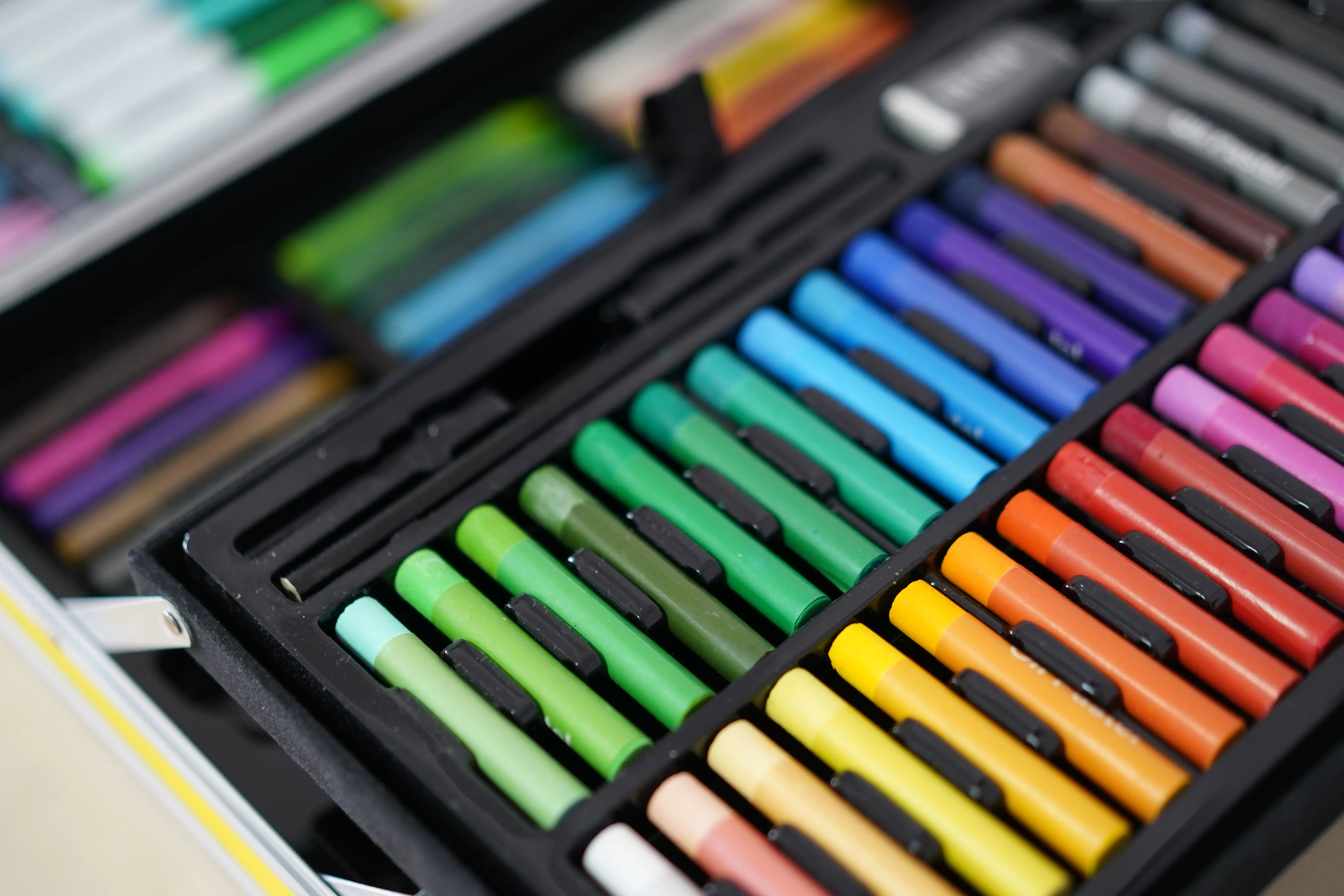 christmas craft kits Close-up of a vibrant assortment of colorful art pastels neatly arranged in a case.