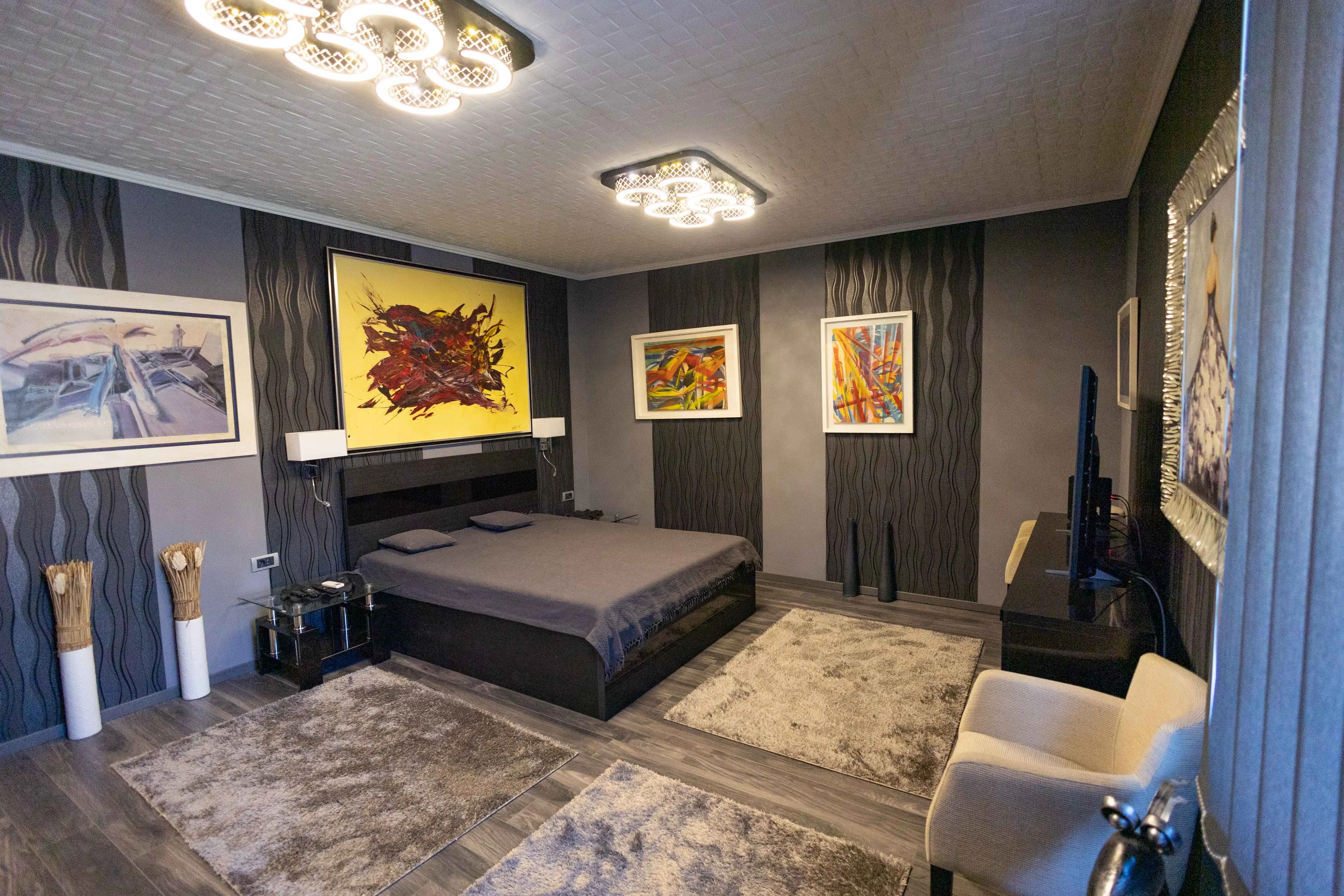 bedroom art Stylish modern bedroom with abstract wall art and elegant lighting.