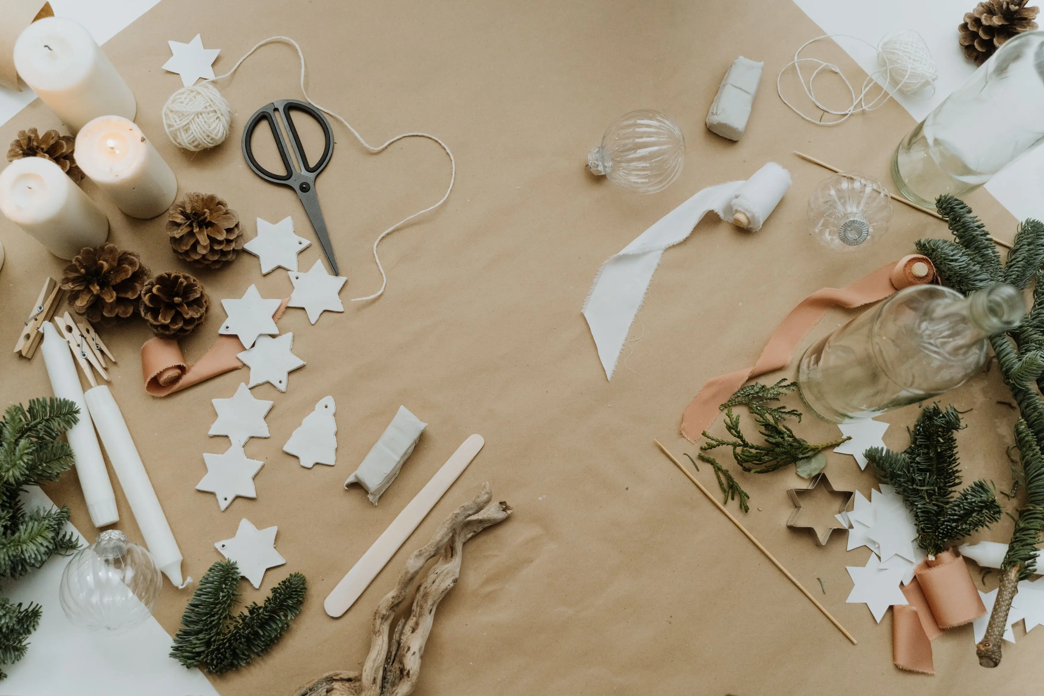 christmas craft kits Flat lay arrangement of Christmas crafts including candles, pine cones, and ornaments.