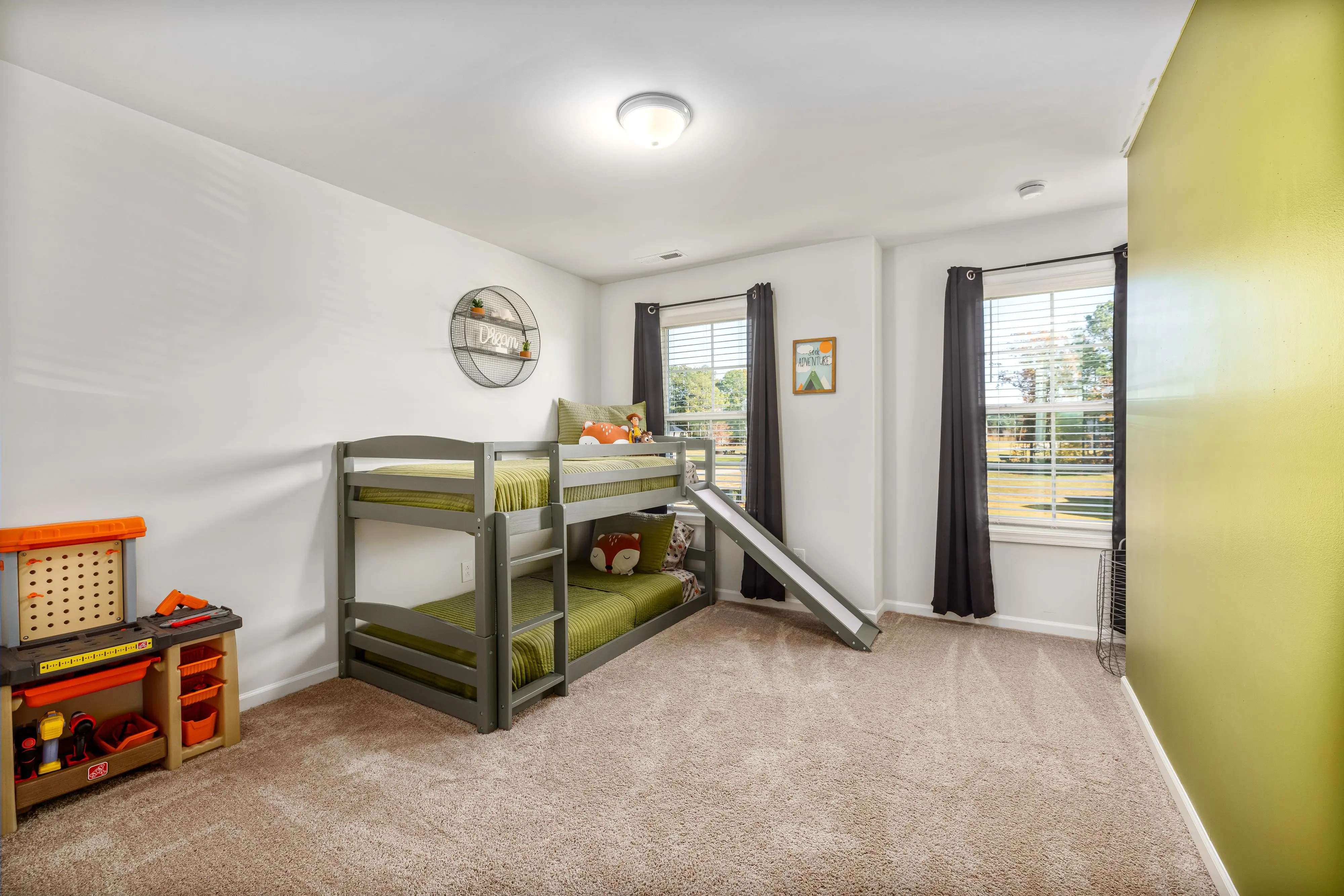 twin platform bed with storage Bright and inviting child's bedroom featuring a bunk bed with a slide and a play area. Perfect for kids.