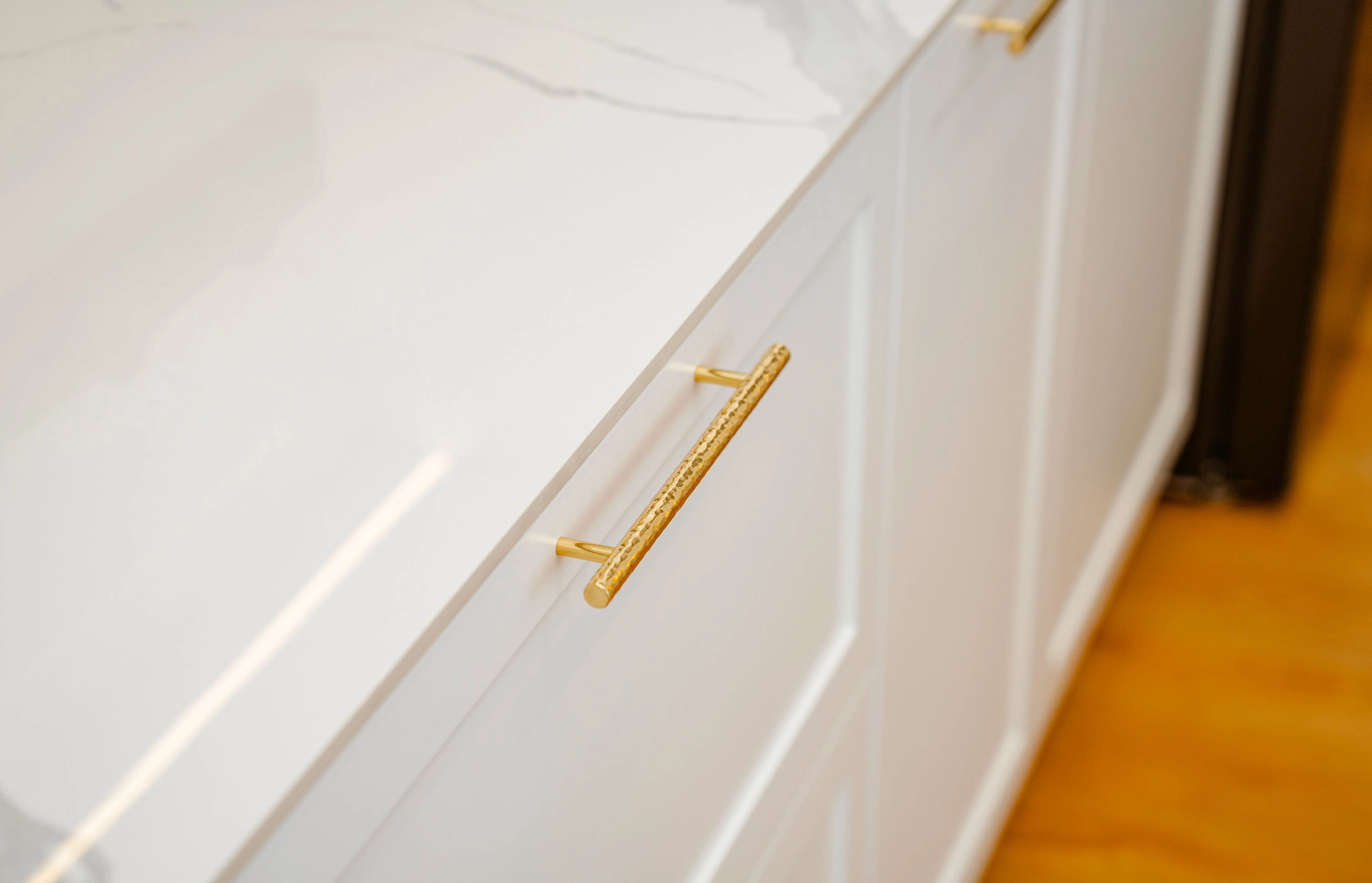 dark gray kitchen cabinets Sophisticated white cabinet with gold handles and marble top, perfect for modern interiors.